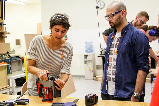 Emma Strebel is leading a wood workshop for undergraduate students.
