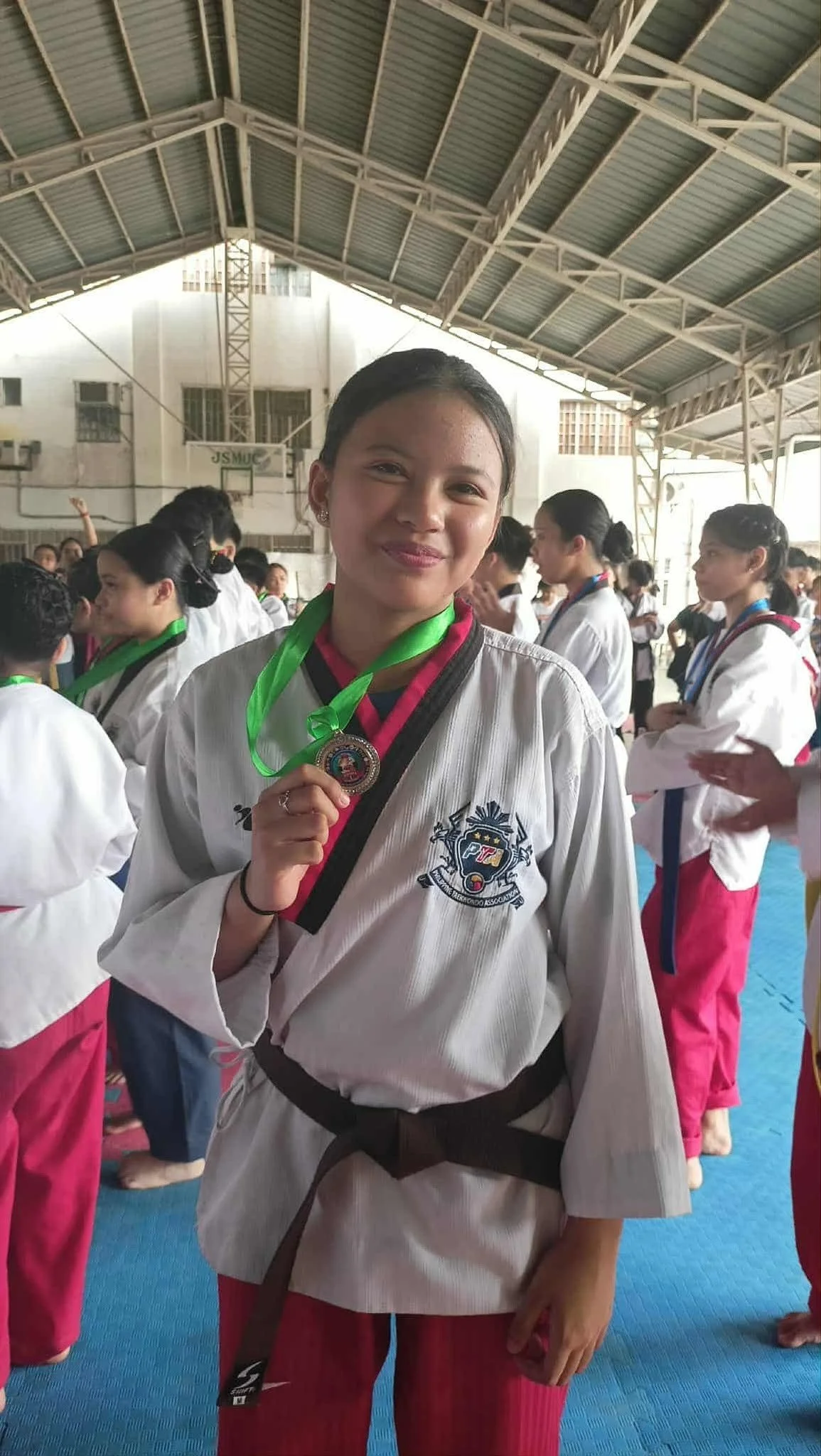 Denisse Servida proudly displays her Silver Medal from the 2025 RIPRISA Taekwondo Competition