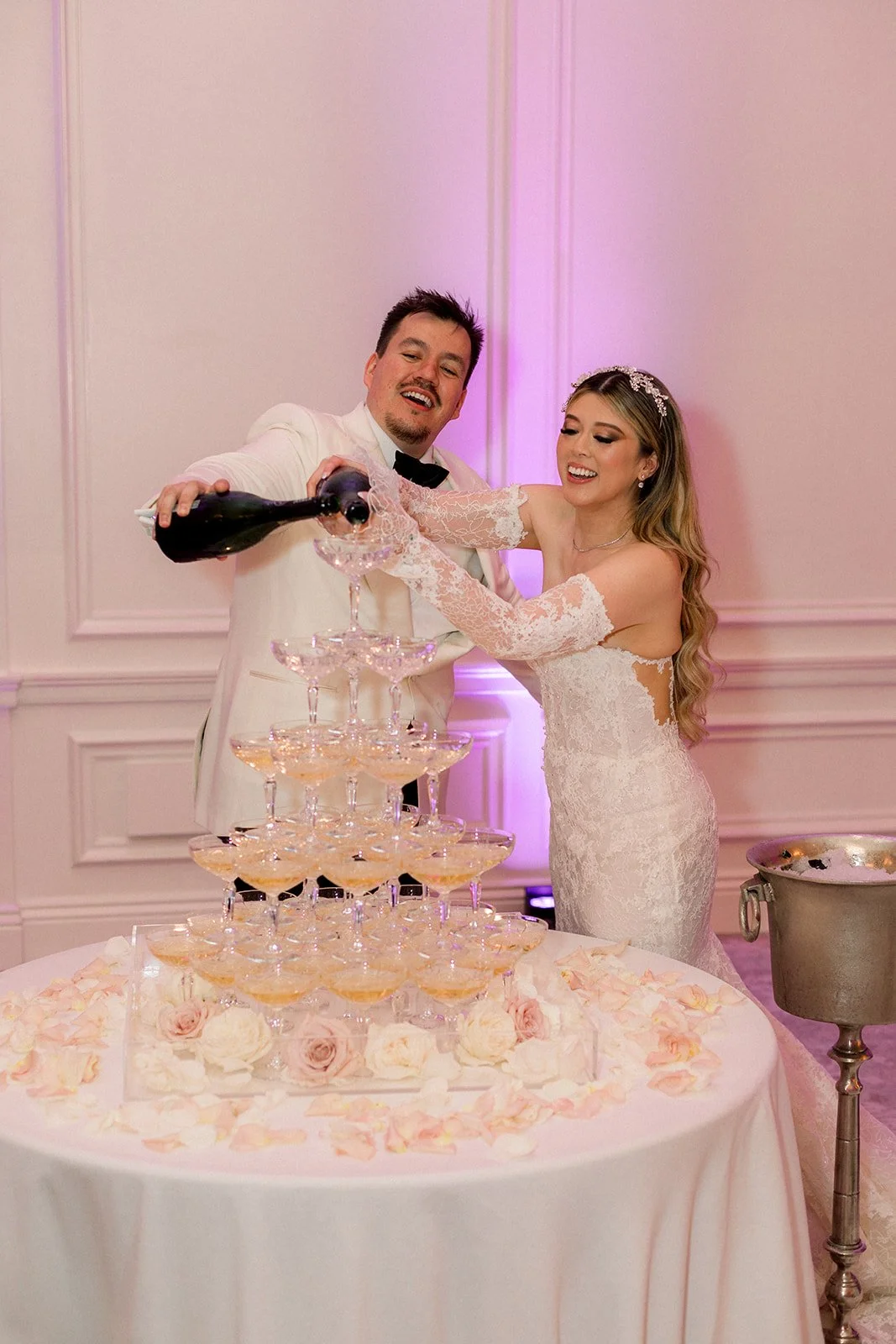 Bride and groom pouring champagne tower at Rosewood Miramar Beach