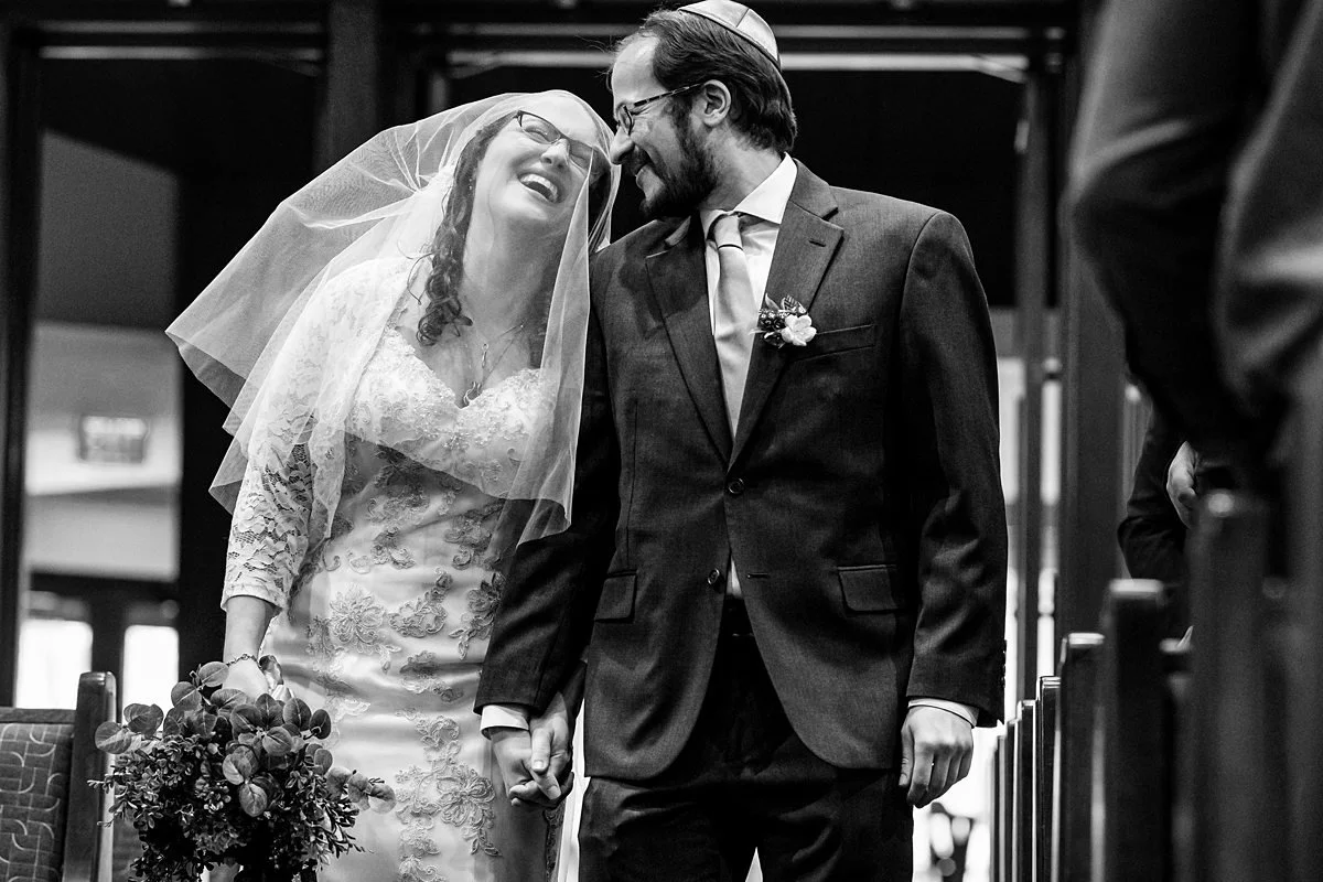 Lin and Eric walk down the aisle together during their wedding at Congregation Etz Chaim in Marietta, Georgia.