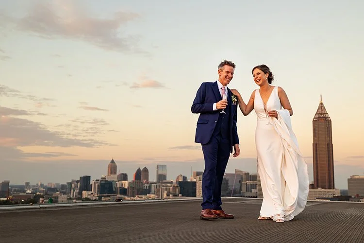Couple posed a top helicoptor pad at Venzanas in Atlanta, photo by wedding photographer Cindy Brown