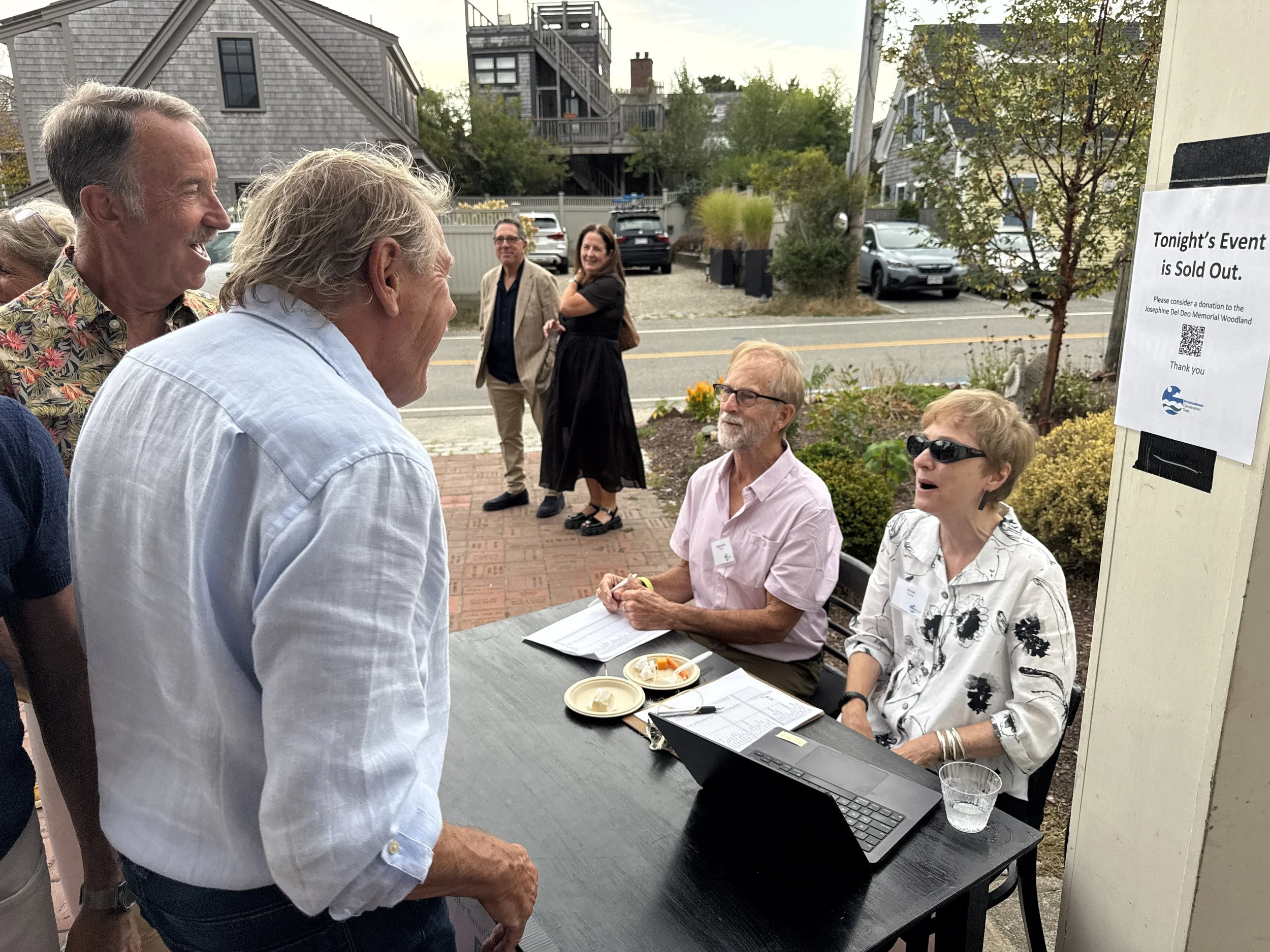 Trustees Douglas Evans and ML Bell helped with check in of guests at the event