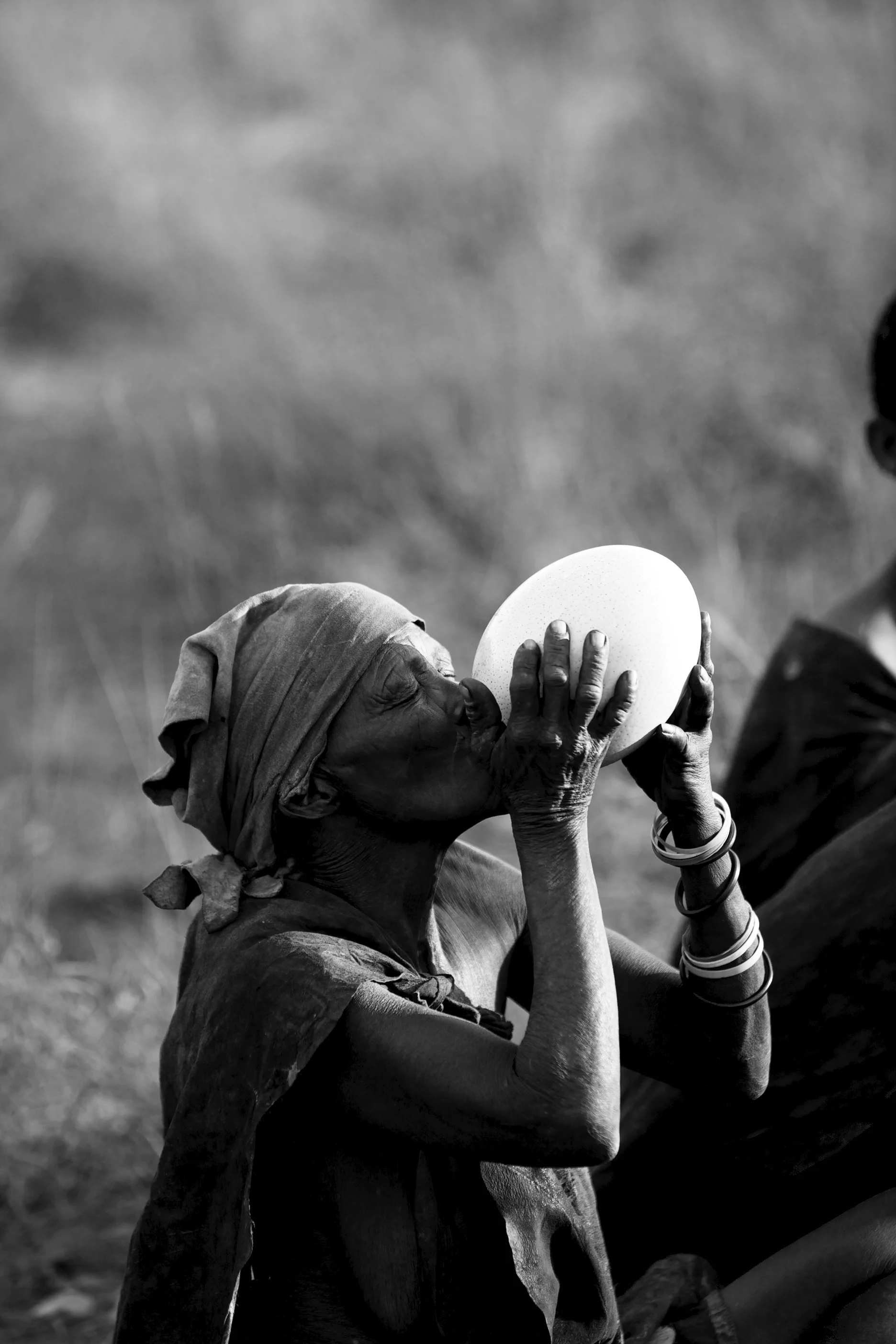 The mother drinks water from an ostrich egg