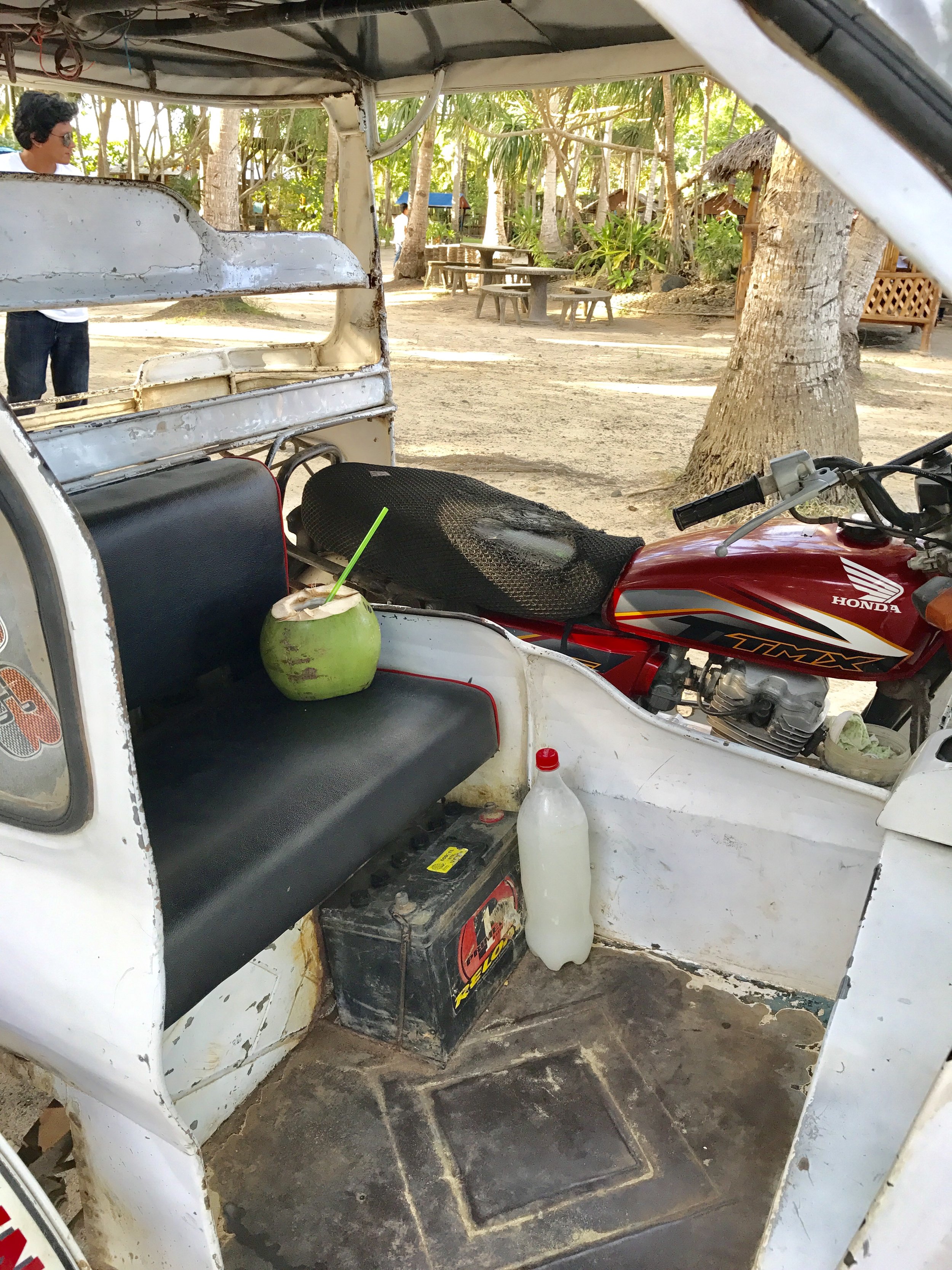 Coconut juice and a bottle of tuba in my tricycle