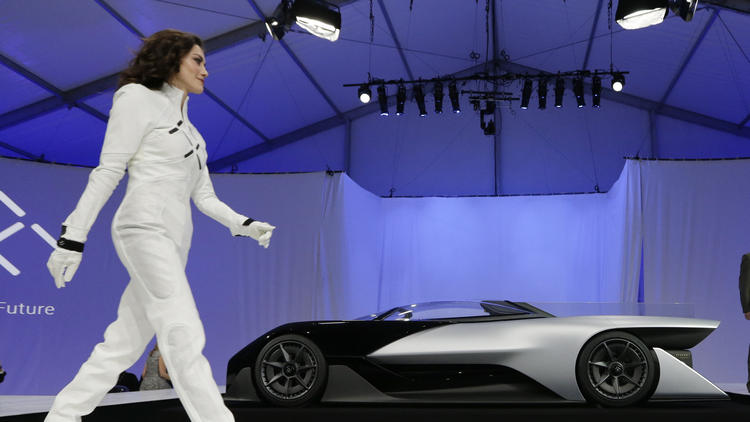 A driver walks in front of the FFZero1 by Faraday Future at CES Unveiled, a media preview event for CES International in Las Vegas in January. (Gregory Bull / Associated Press)