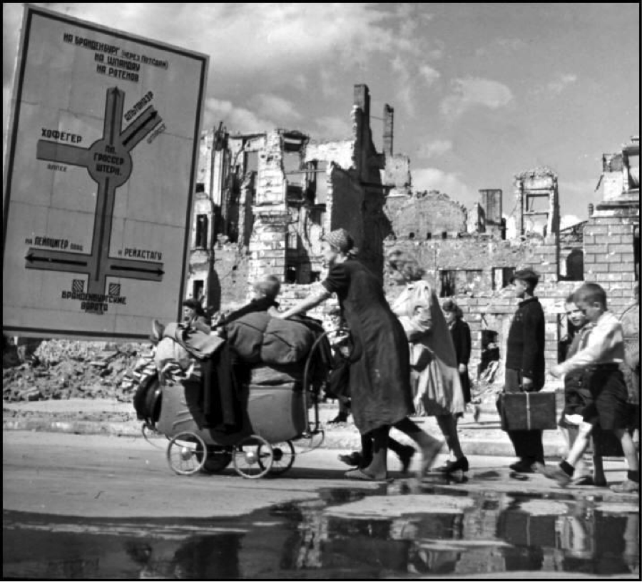Robert Capa © International Center Berlin. 1945. Refugees making their way through the ruined Soviet sector.