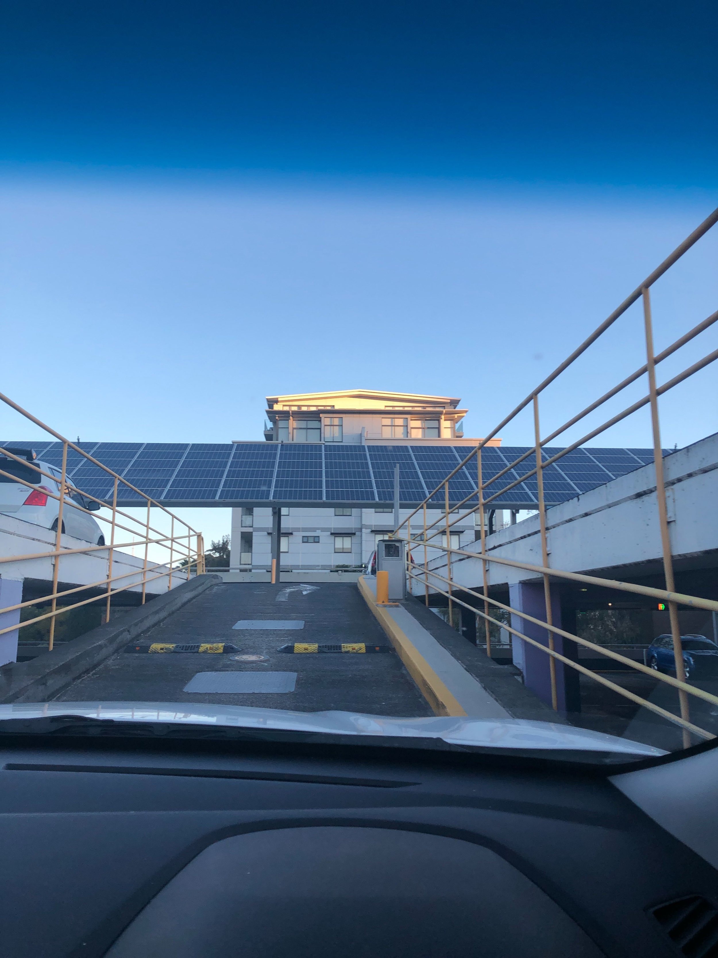 Continue on up the ramps until you see rooftop parking with the satellites. Turn Right and immediately Turn Right again.