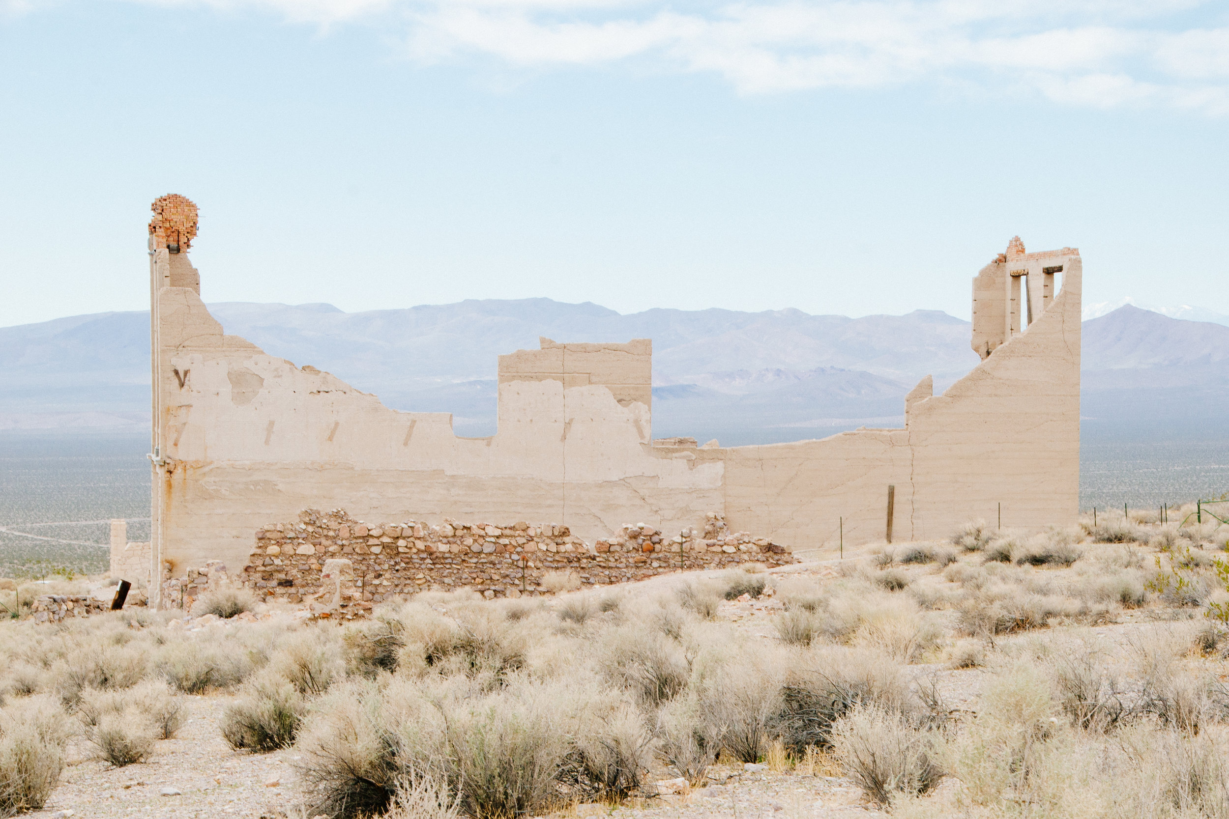 Built just outside Death Valley in 1905, Rhyolite, NV was home base for gold rush miners. The town's peak population might have been as high as 5000. However, just 5 years after it was founded, Rhyolite's population began falling as reports surfaced that the accompanying mines were overvalued. By 1920, the town's population was 14. This is all that remains of the town bank, that was once appointed with marble floors and stained-glass windows.
