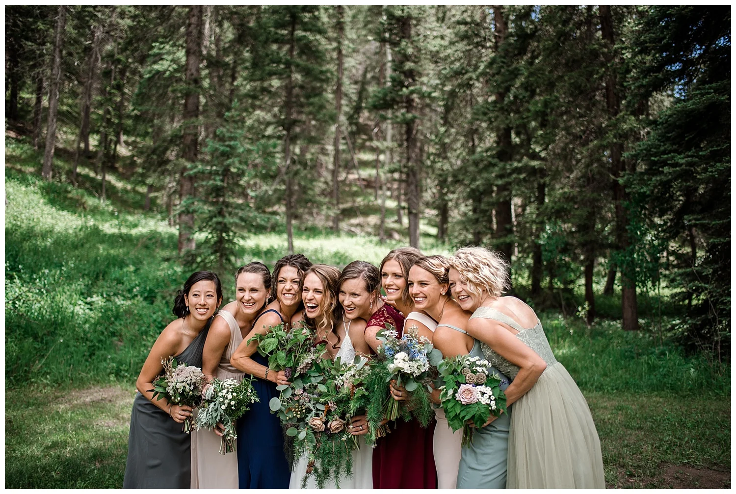 wedding party portraits at Beaver Ranch in Conifer Colorado, Colorado Wedding Photographer, Rocky Mountain Wedding Photographer, Intimate Colorado Wedding Photographer, bridesmaids laughing in jewel toned dresses