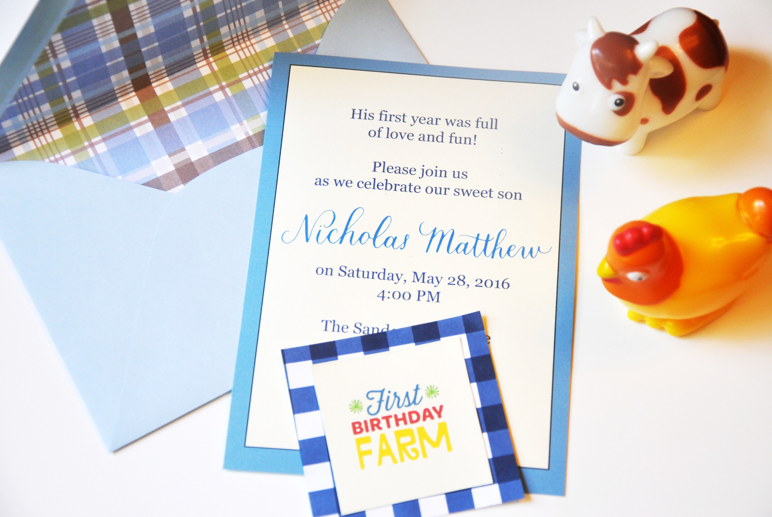 The invitation included simple script and type printed on ivory Papersource cardstock and light blue Papersource envelopes that I lined with cute scrapbook paper. The printable is from Fisher-Price's website. The printables were used as cake toppers and centerpieces.