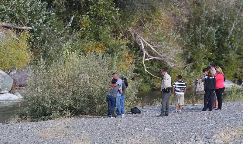 Retired Chaplain Holly Berkley tends to a family at the scene of a drowning. Photo courtesy of the Press Democrat.