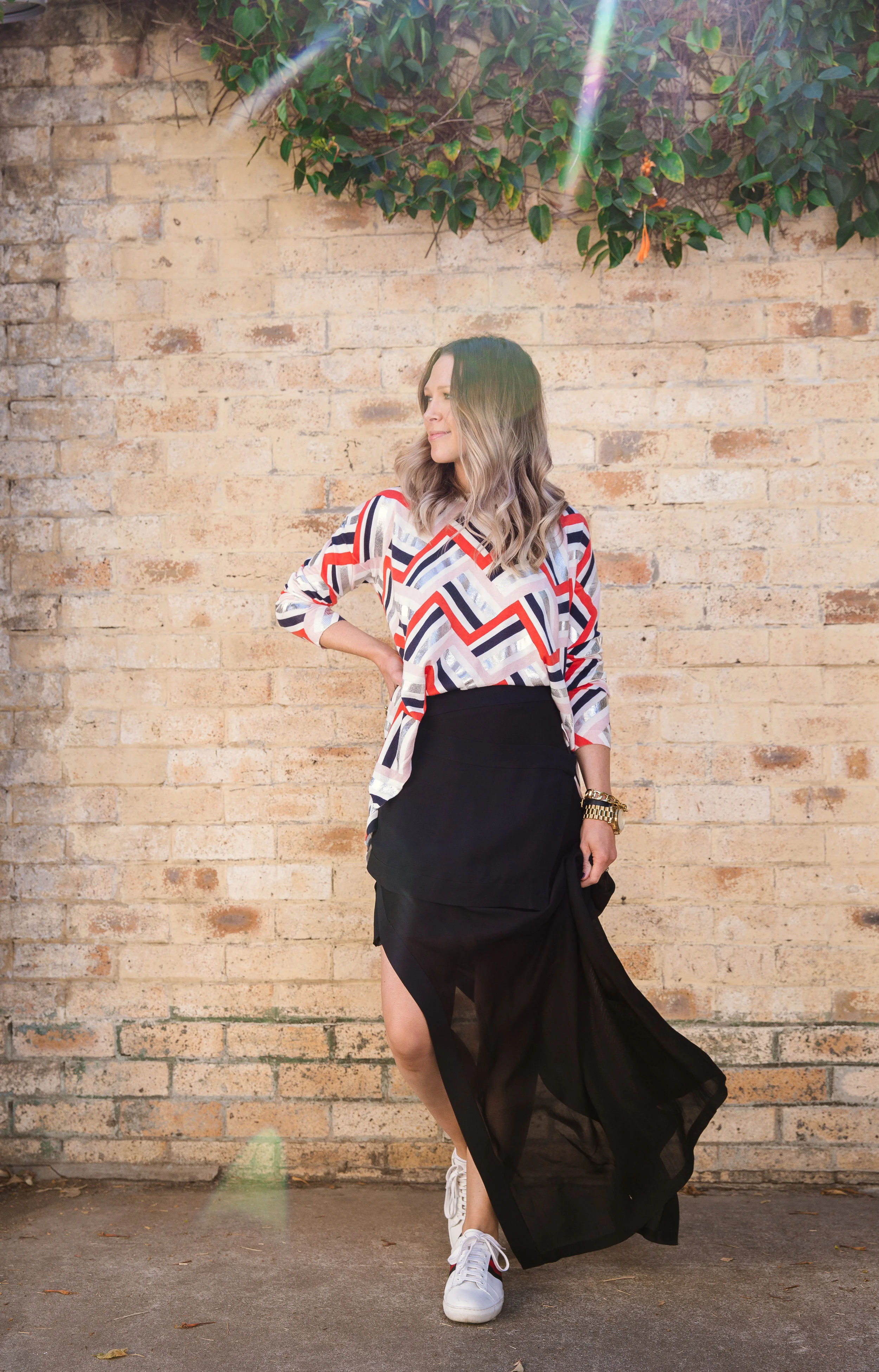Everything and I mean EVERYTHING can be pared back with a sneaker! Love Bound Jumper + Near and Far Skirt. Image by Sophia Aarons.