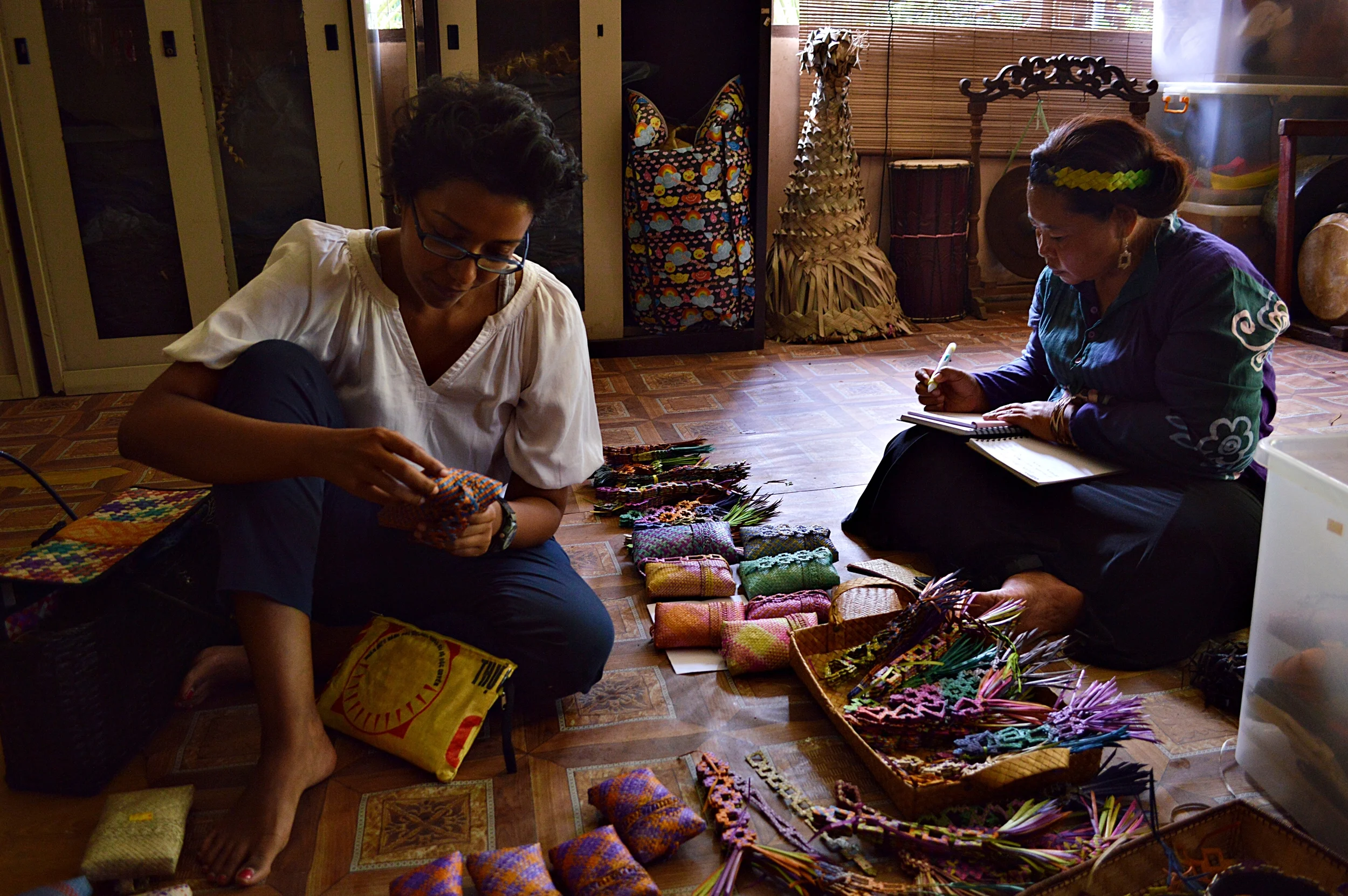 Founder of Earth Heir, Sasi, looking over some products with a woman from the Mah Meri indigenous tribe.