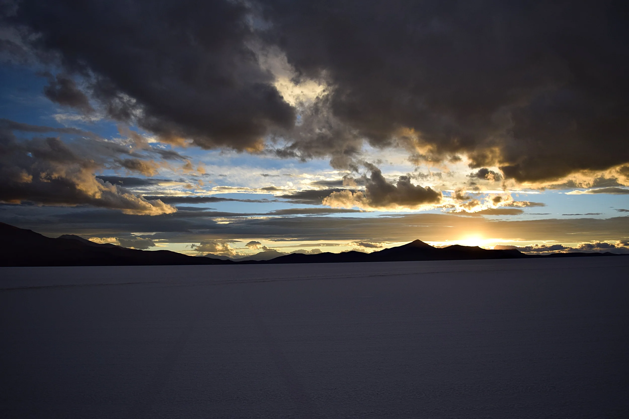 One of my favorite sunsets on this trip—a storm approaching from one side and a rainbow behind me. Salar de Uyuni.