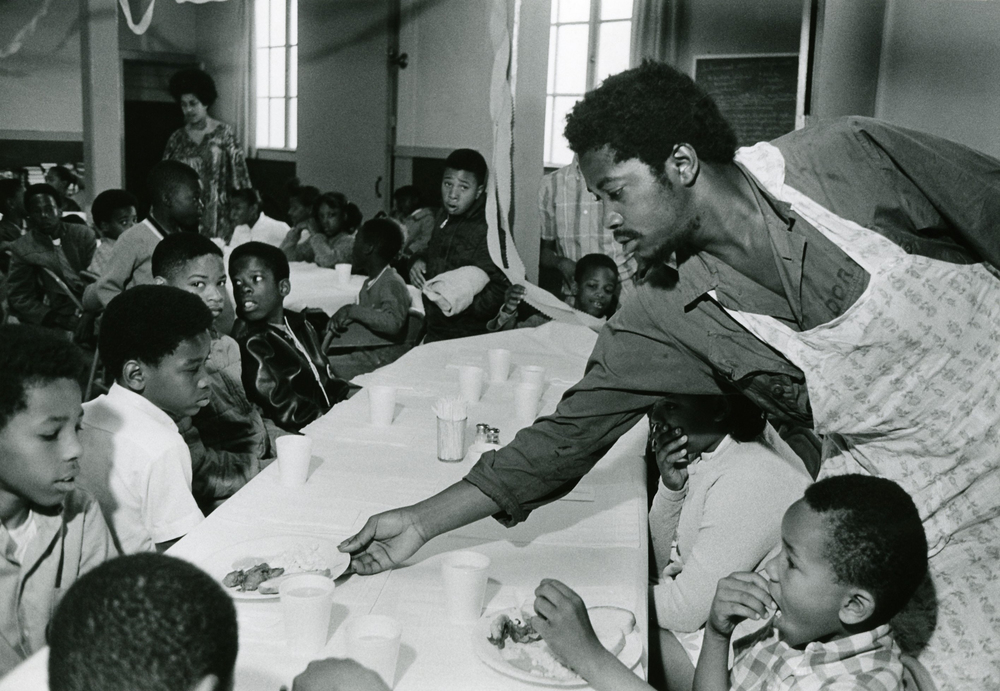 black+panthers+dogwoof+document#2+Charles+Bursey+hands+plate+of+food+to+a+child+seated+at+Free+Breakfast+Program.++Photo+courtesy+of+Pirkle+Jones+and+Ruth-Marion+Baruch.PJ_v1.jpg