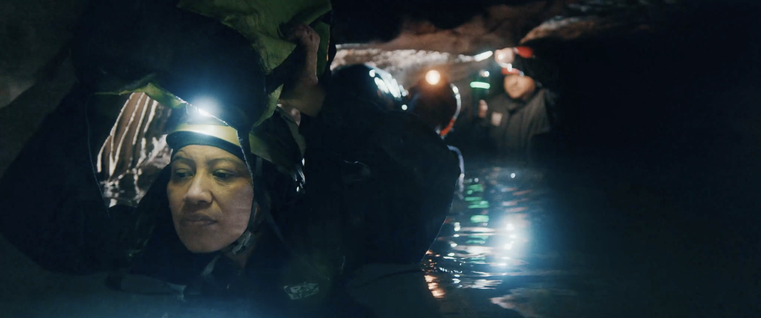 8. Fatima + team walk through water.png