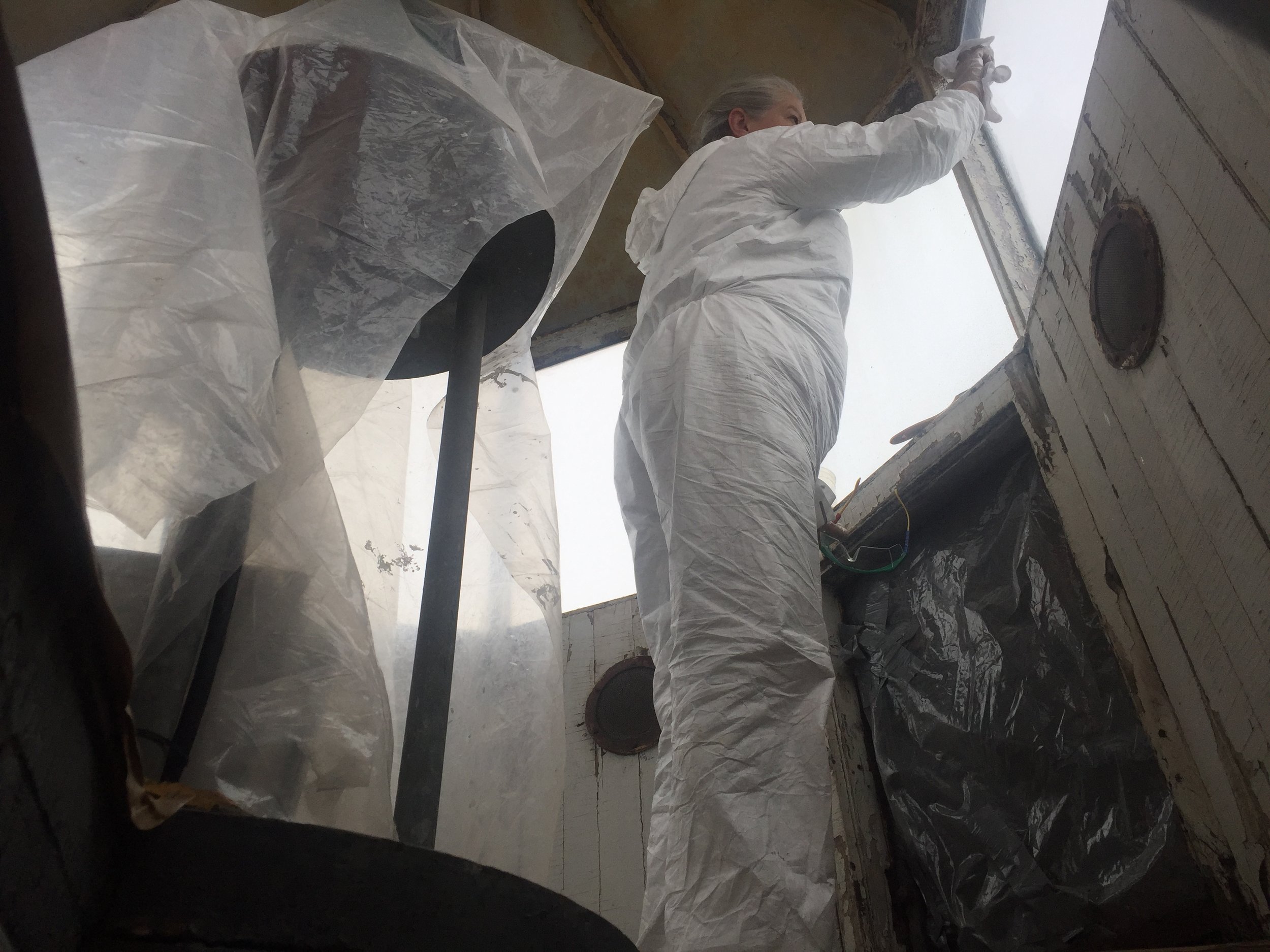 Eileen applying sealant to the window surrounds.