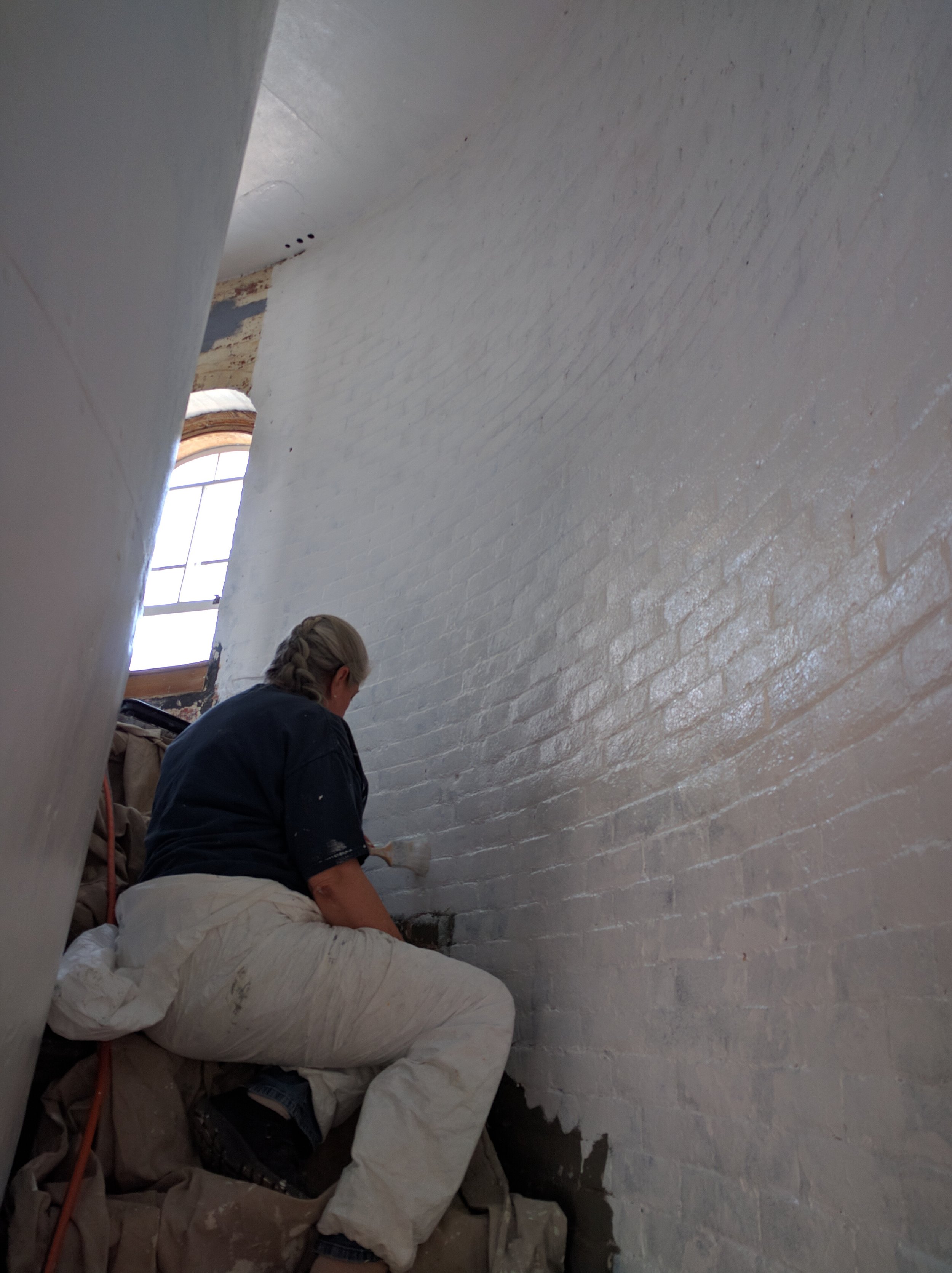 Eileen painting the stairwell.