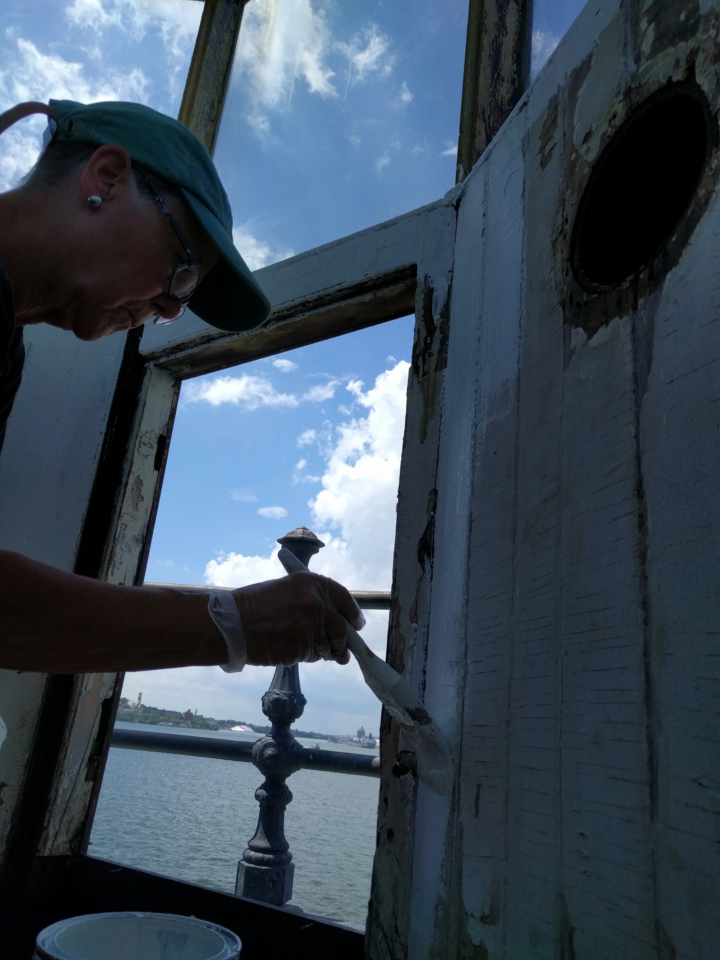 Laura painting the beadboard in the Lantern Gallery.