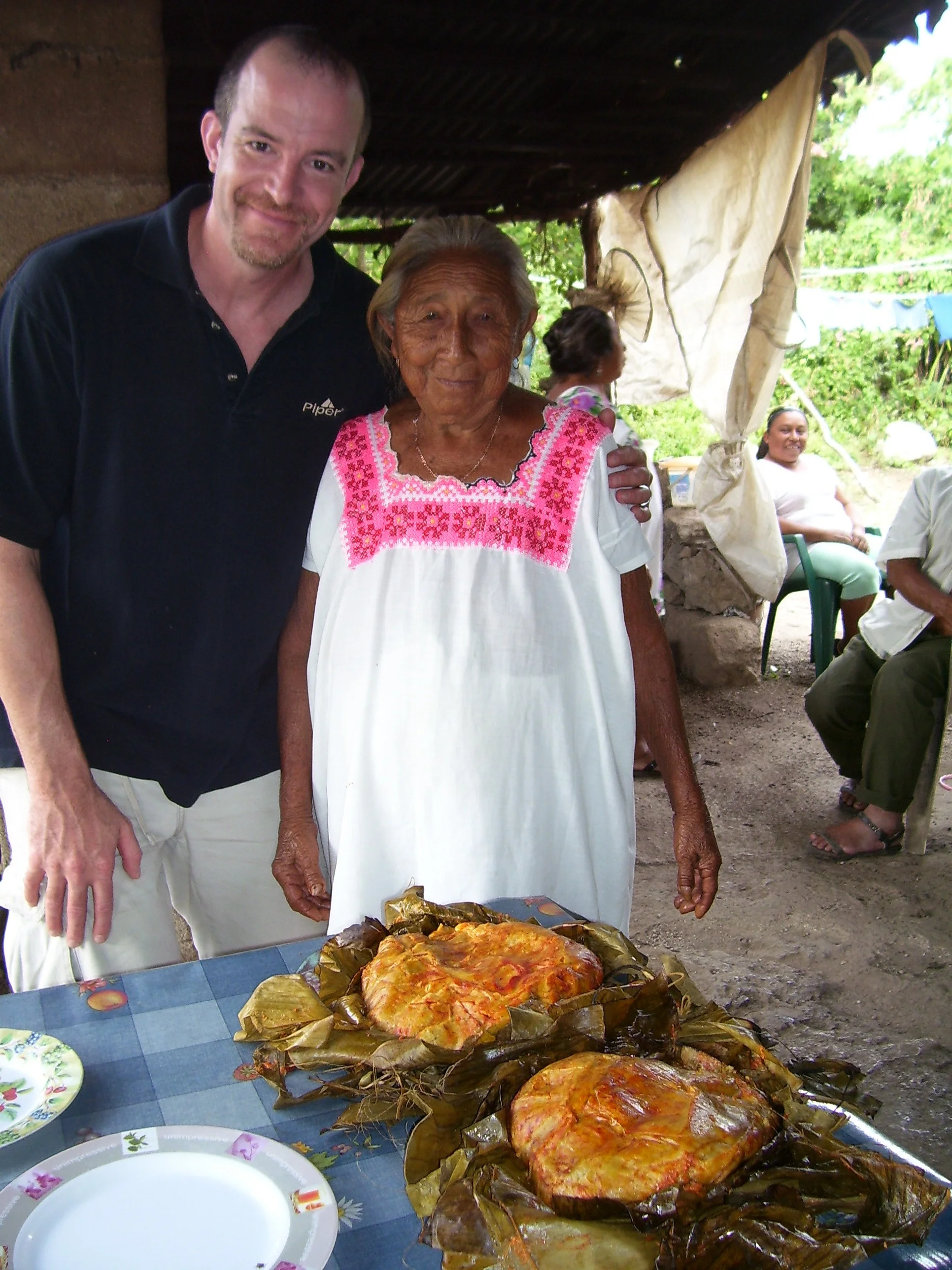 Chris and Man Goya with Pibil Tamales cooked in the earth.