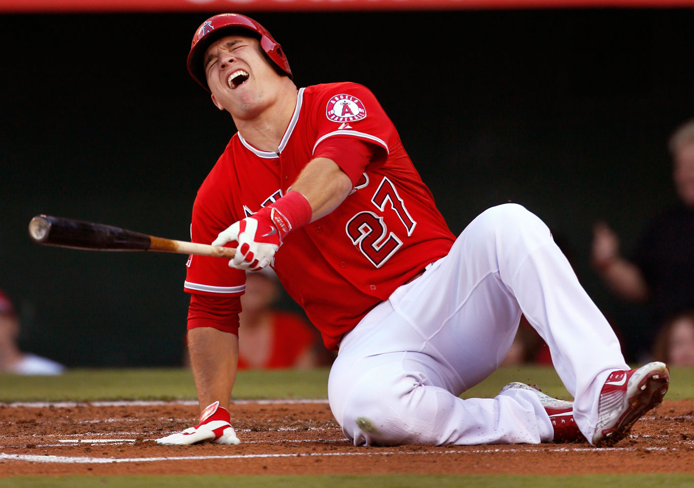  Mike Trout grimaces after being hit by a foul tip off his foot in the first inning of the game with the Seattle Mariners at Angel Stadium. 