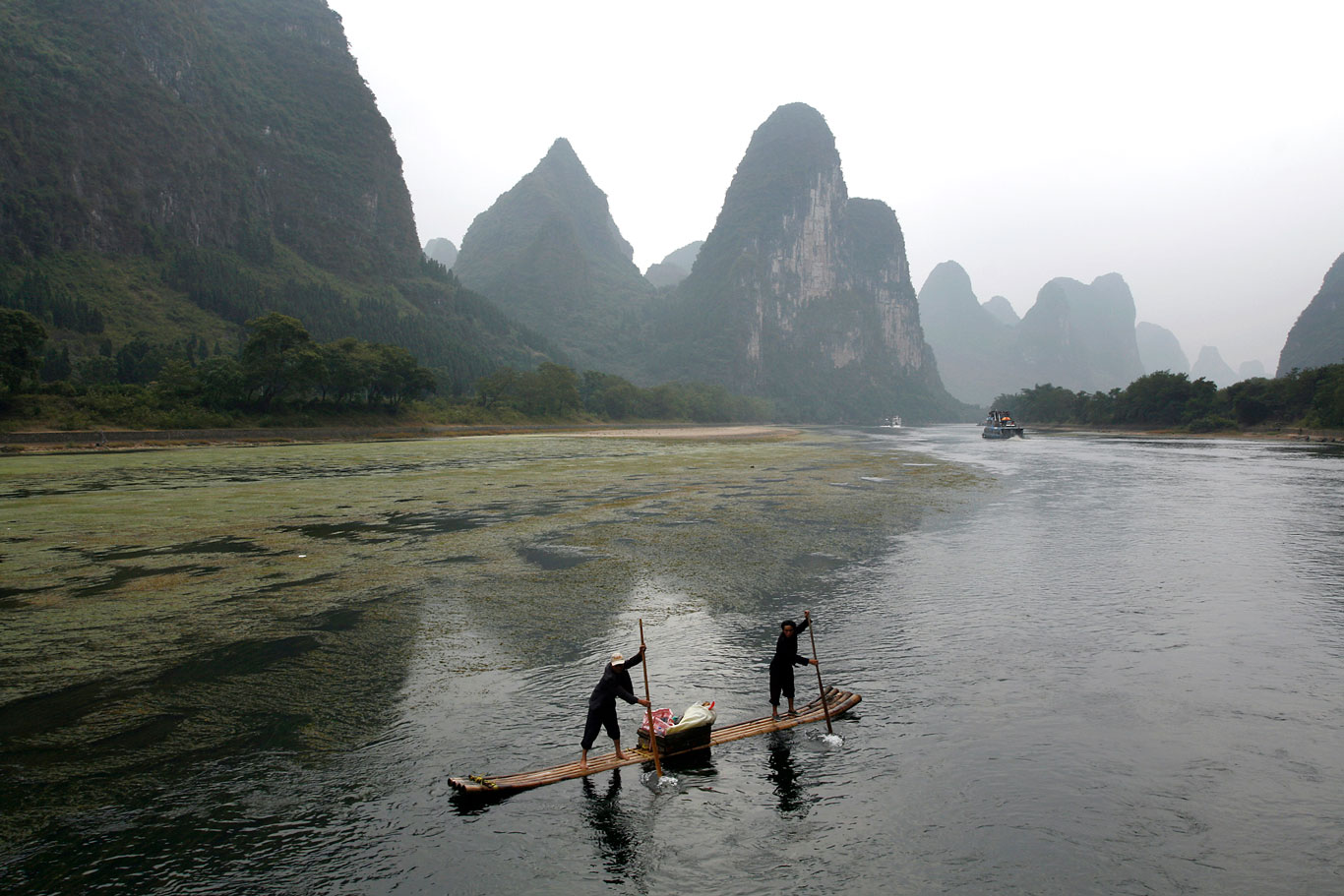  Men paddle a bamboo boat on the River Li in the Guangxi region of China. 