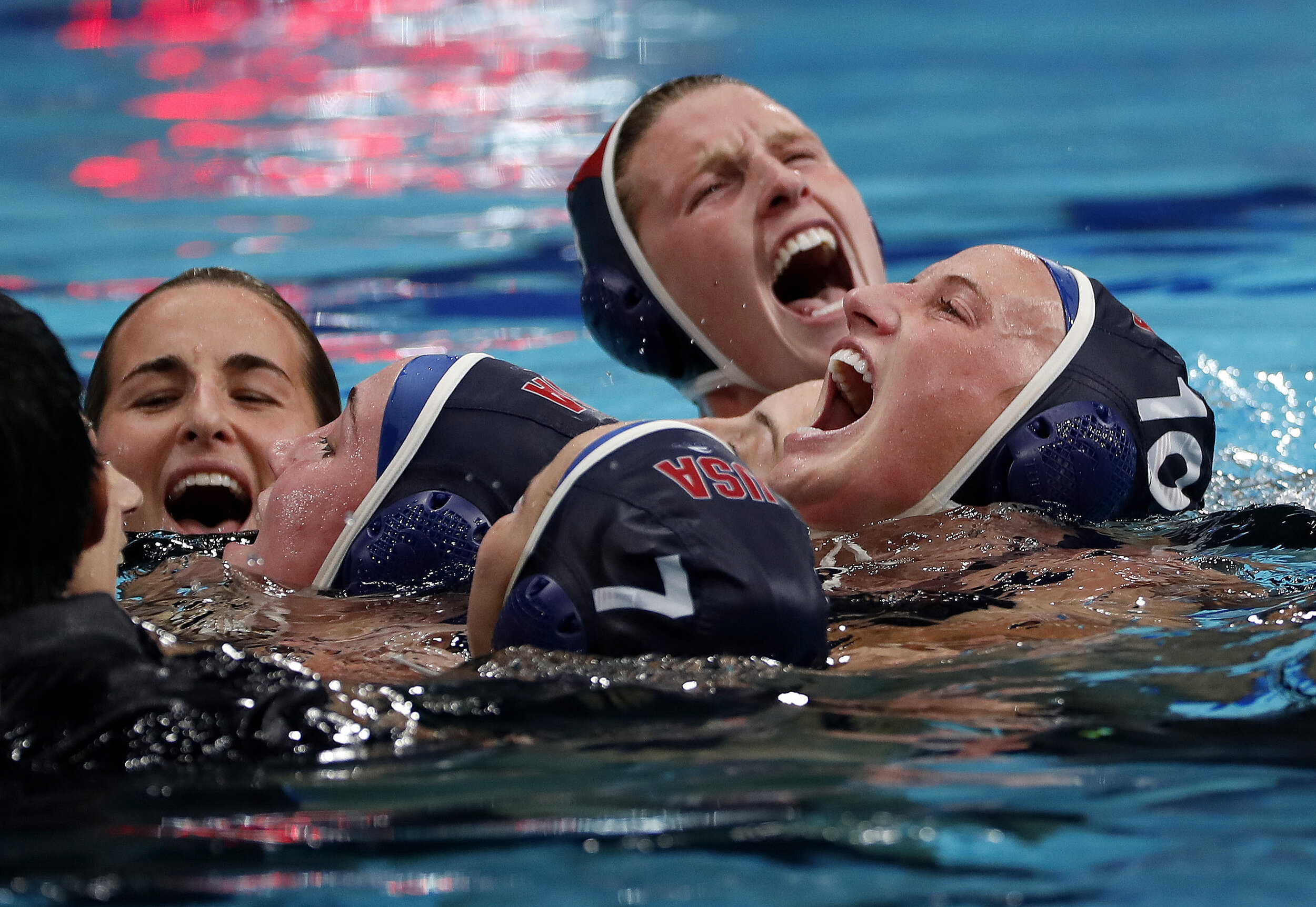  U.S. water Polo player Kaleigh Gilchrist on right celebrates with teammates after beating Spain for a gold medal at the Tokyo Olympics. 