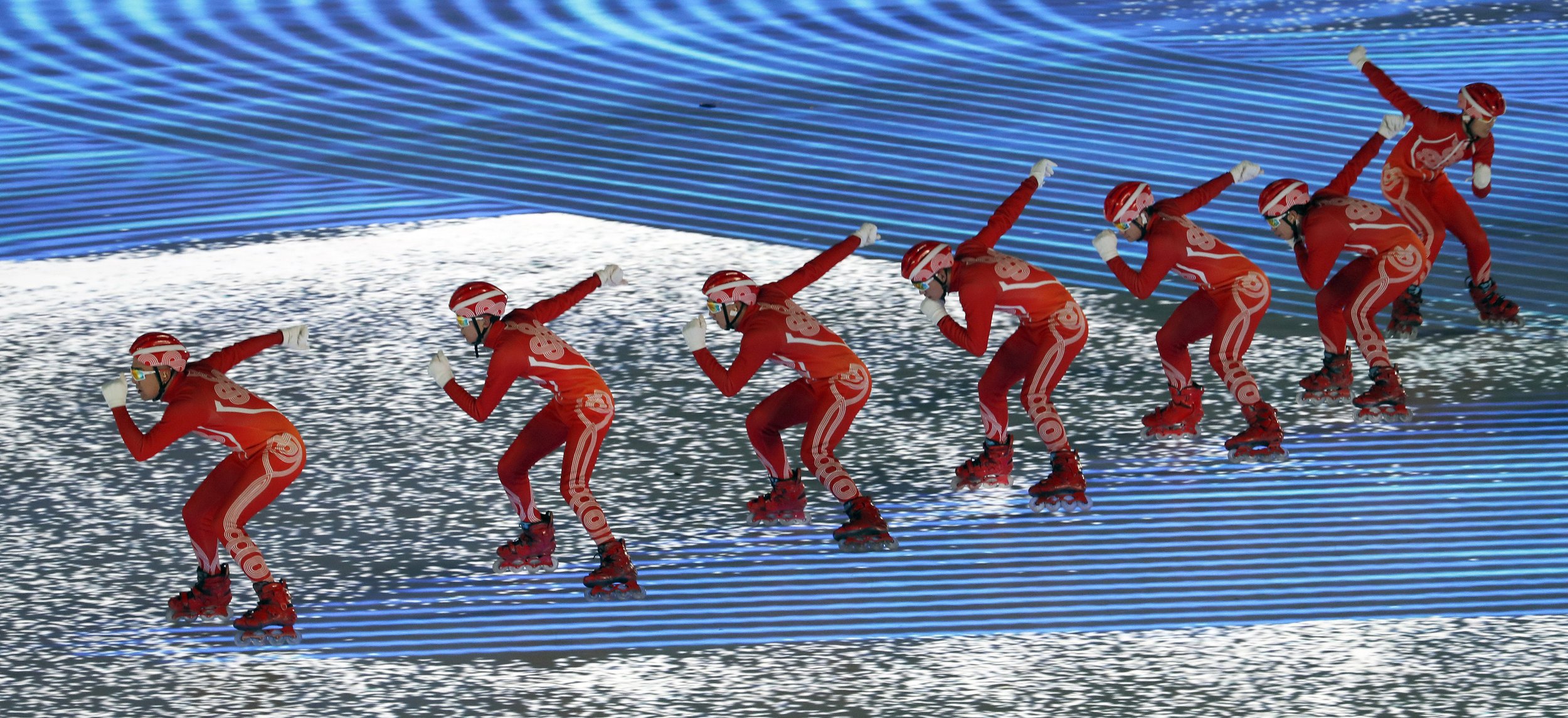  Rollerbladers surf across projections during the opening ceremony of the Beijing Olympic winter games. 