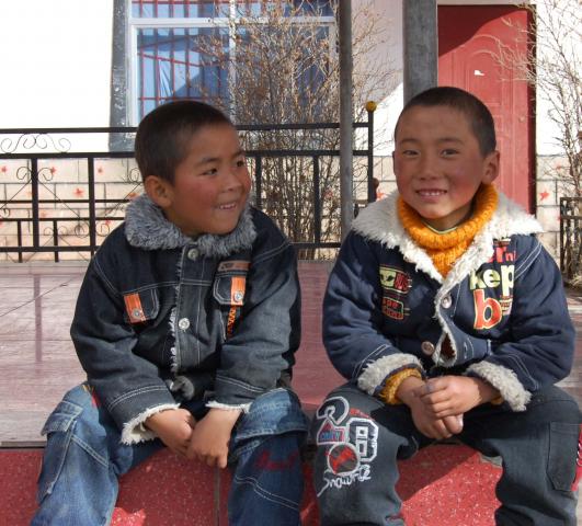Two boys resting for a bit while playing