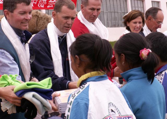 Handing out stocking caps & school supplies to over 80 children