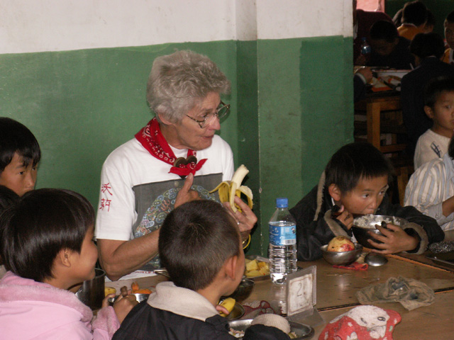 Marilyn eating lunch at orphanage in Lijiang