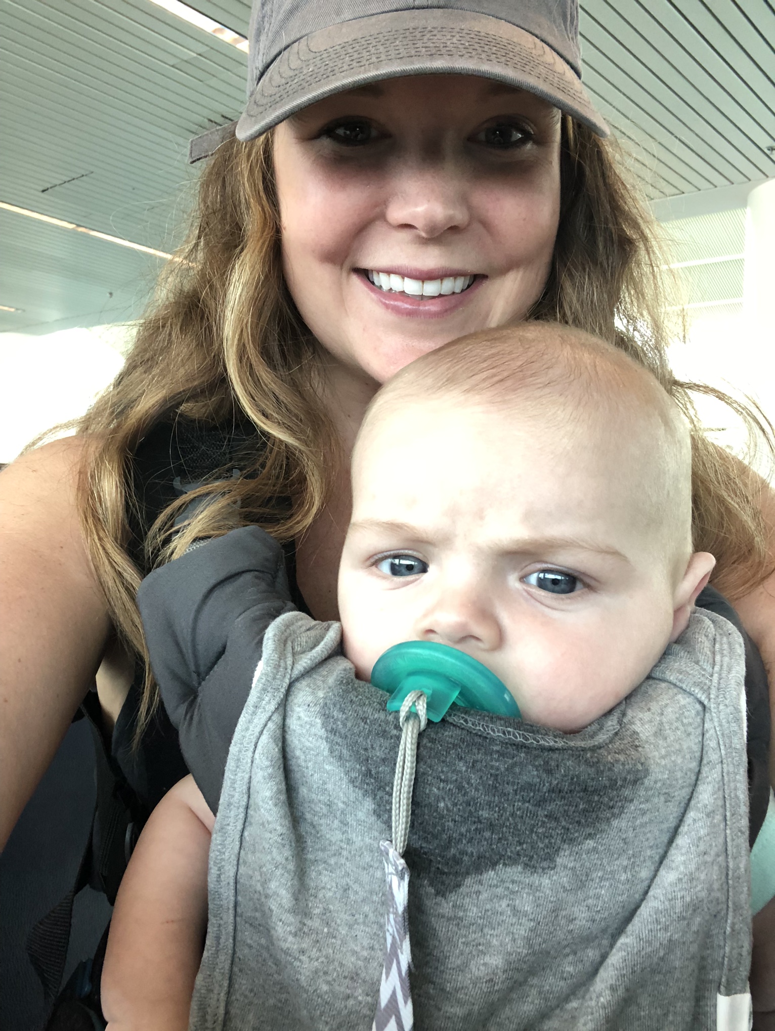 Waiting in Portland airport for our flight to leave. Wearing the baby & all his drool :)