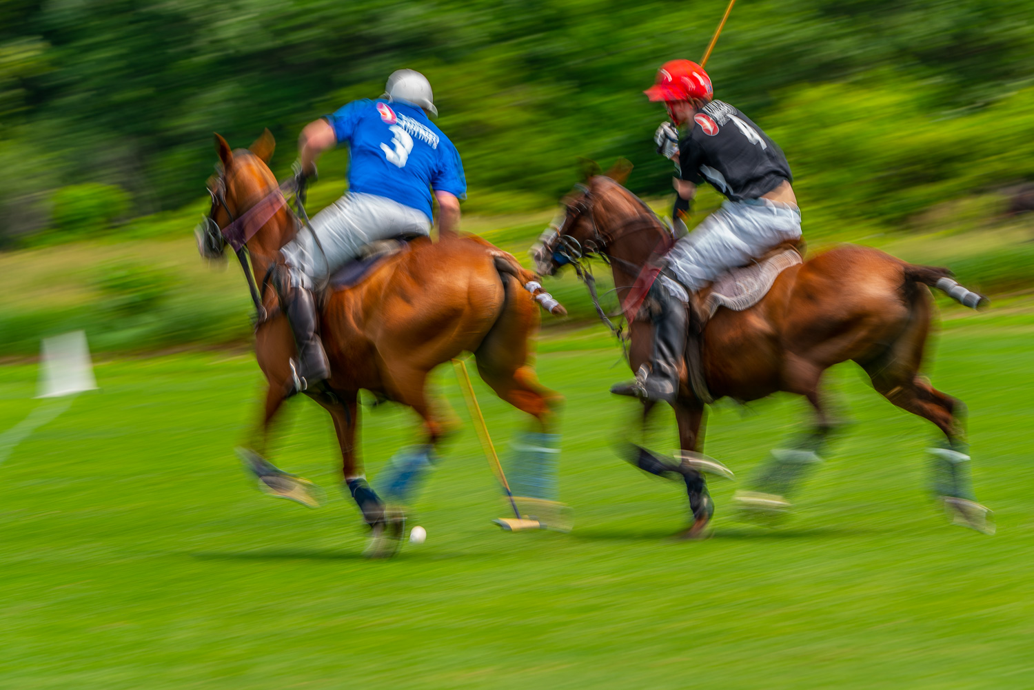 _Battling for the ball at the Mashomack Polo Club in pine plains, ny.  Blurs create a sense of speed in the image..jpg