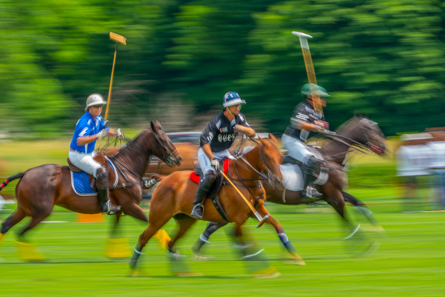 polo players racing for the ball in a blur at the mashomack polo club in pine plains.jpg