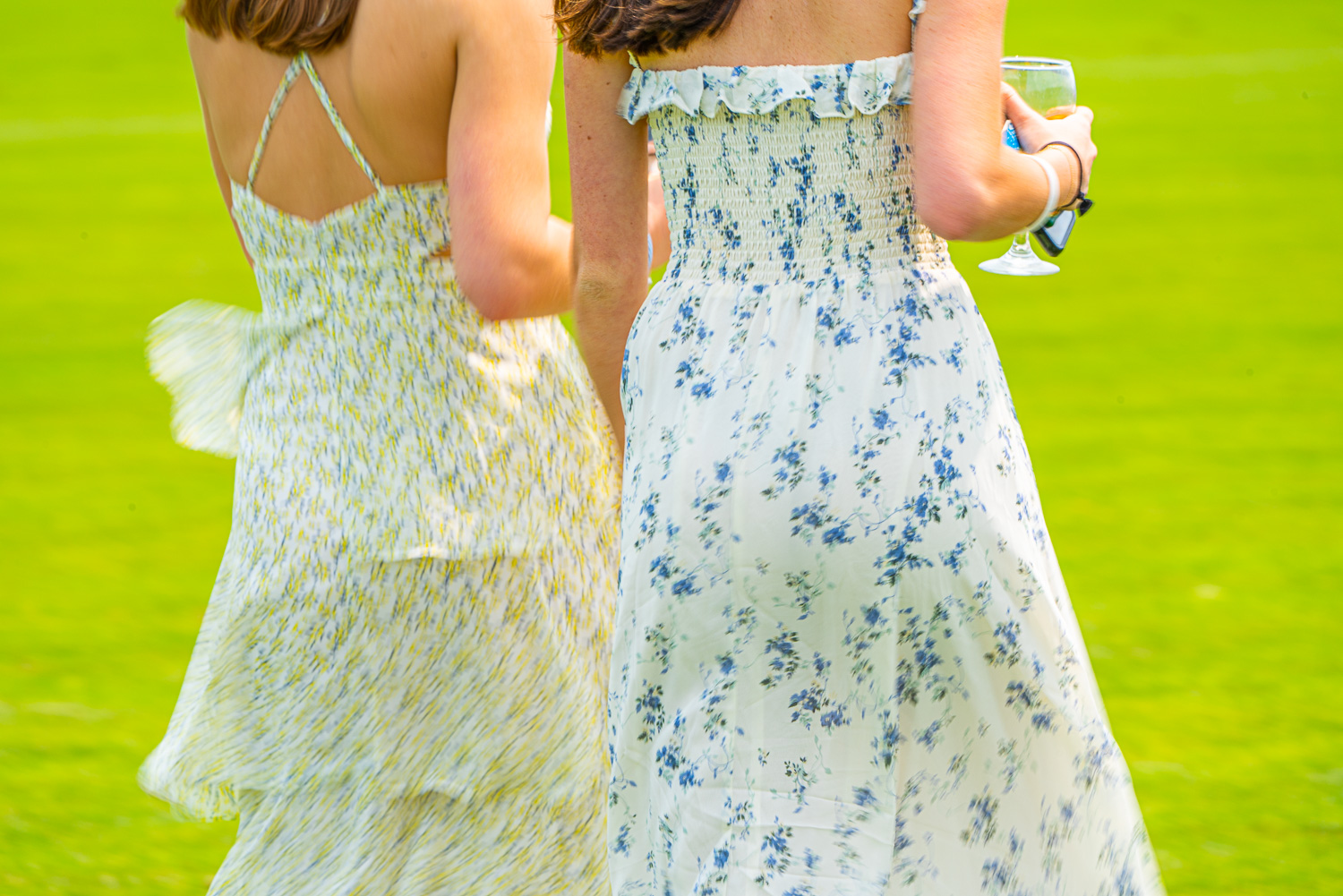 Two women dress for the occasion. Polo anyone at the Mashomack Polo Club, pine plans, ny.  The action blur creats a sense of speed and movement..jpg