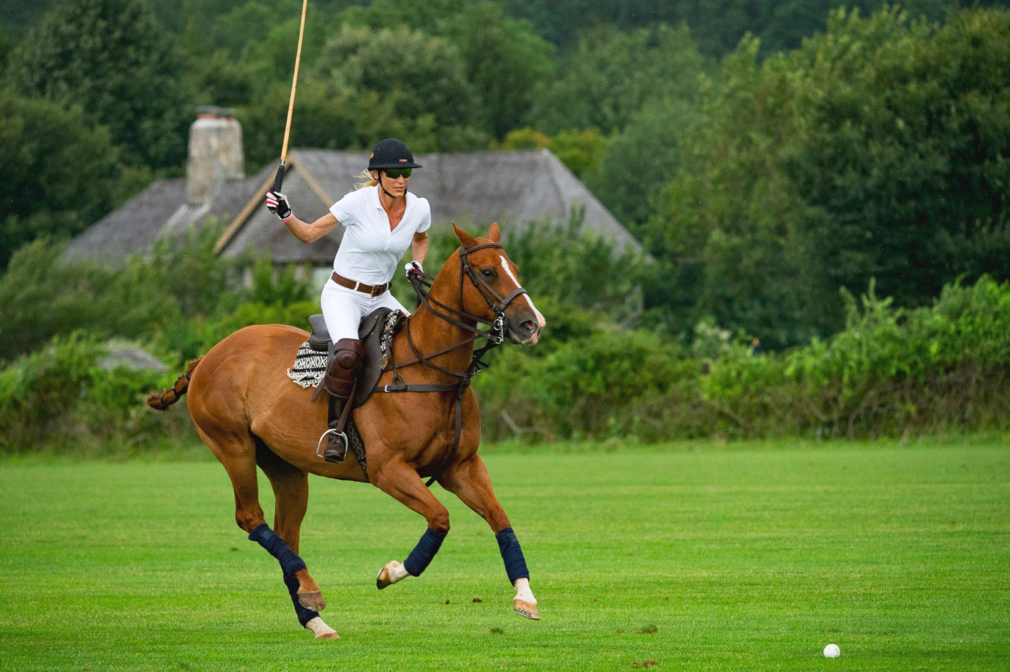 Danielle tosi one of the women polo playuers at the Southampton Polo Club takes a swing. Woment mix it up with the men. Intermural..jpg