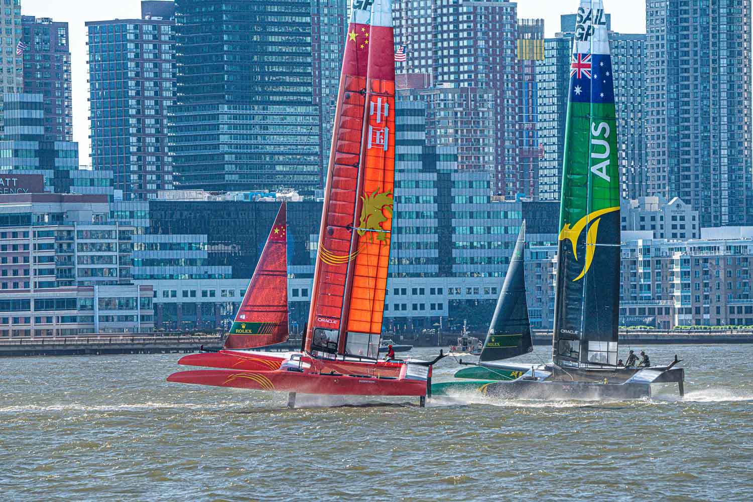 With Jersey City in the background the Sail GP race on the hudson begins.  Boats accelerater onto their hydrofoils almost immediately.jpg