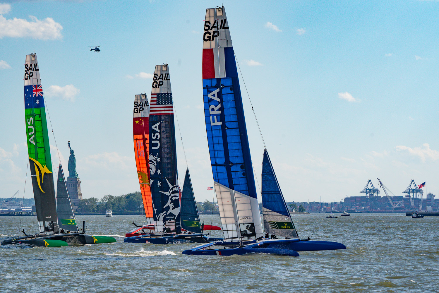 The sail GP boughts are in a tight race at this point. The statue of liberty sits in the background on the Hudson River.jpg