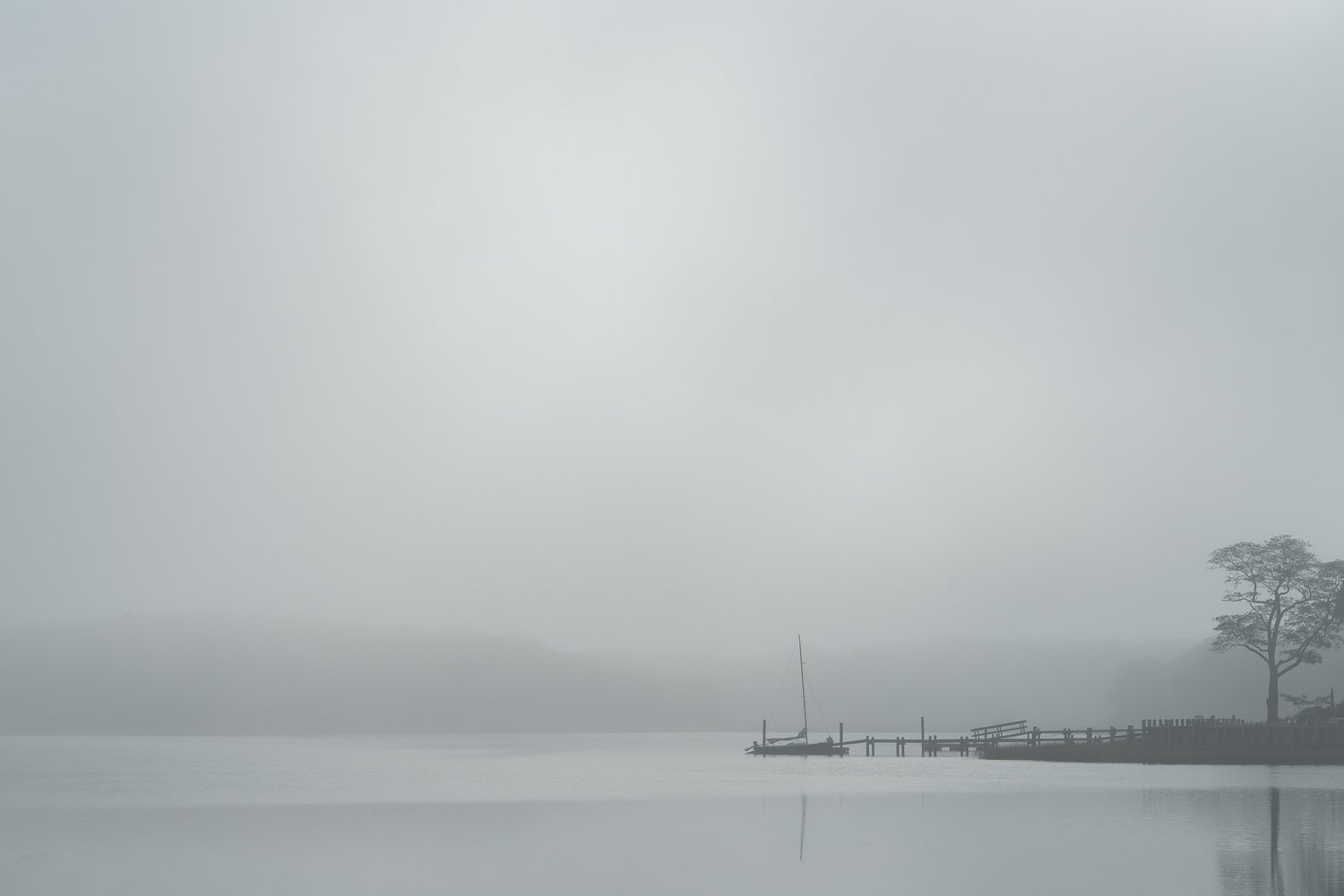  Sailboat docked in heavy fog 