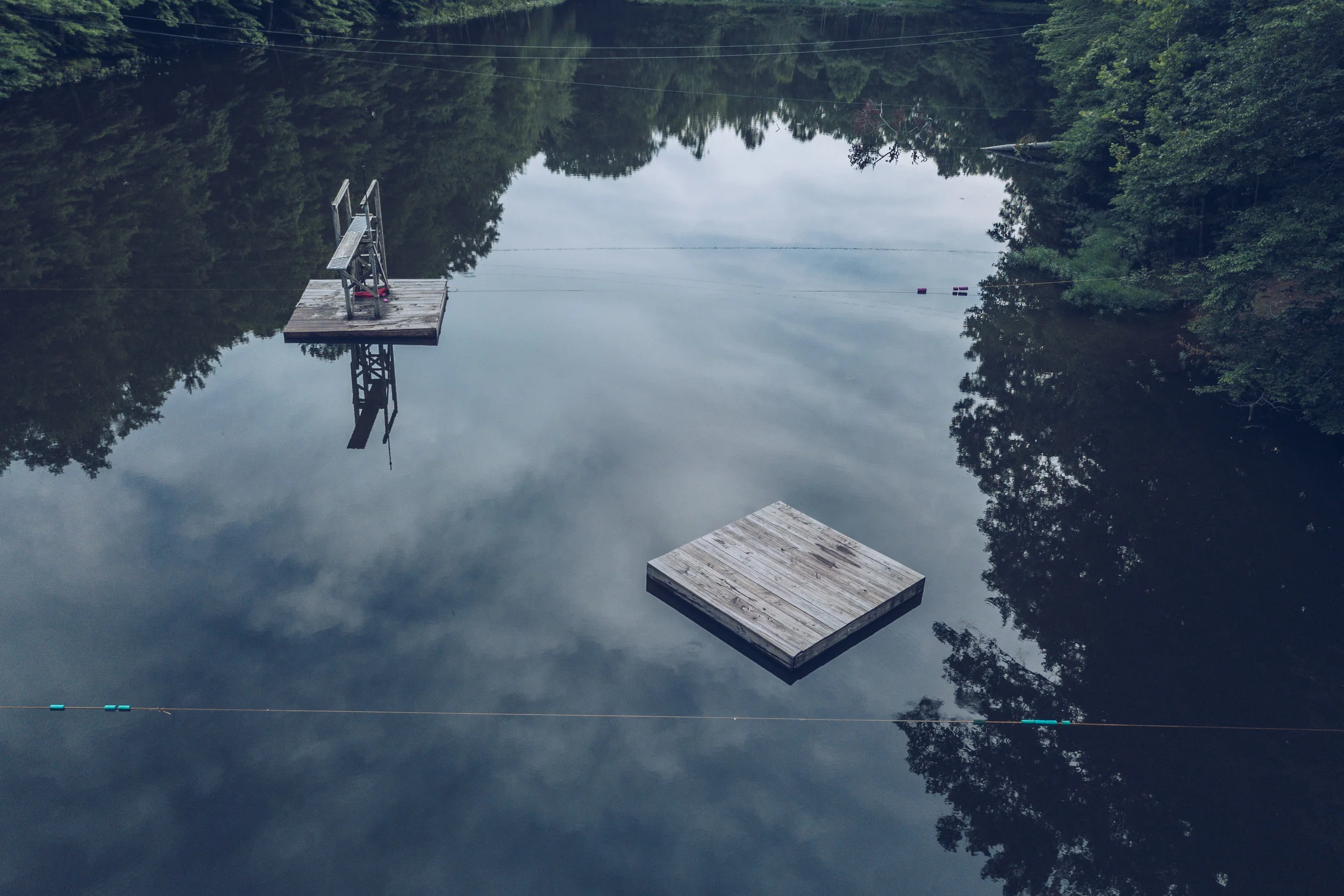 My home away from home. Camp Palawopec's gorgeous lake, dive tower, and raft waiting for swimmers.