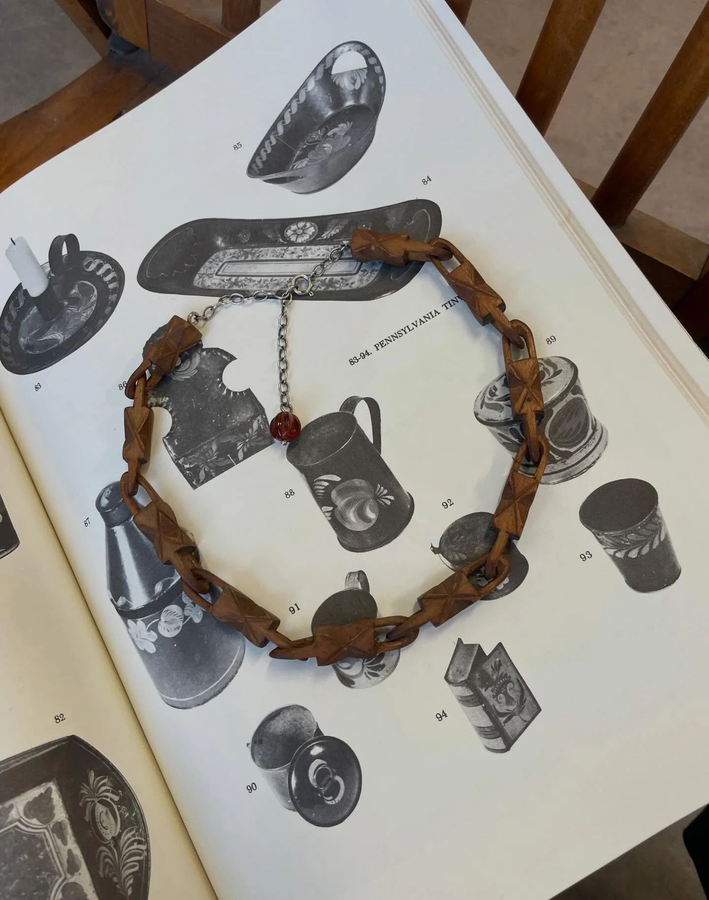 Picked up this lovely piece of folk art whimsy yesterday. Decorative chain carved from one solid piece of wood. Sterling silver clasp and glass bead.