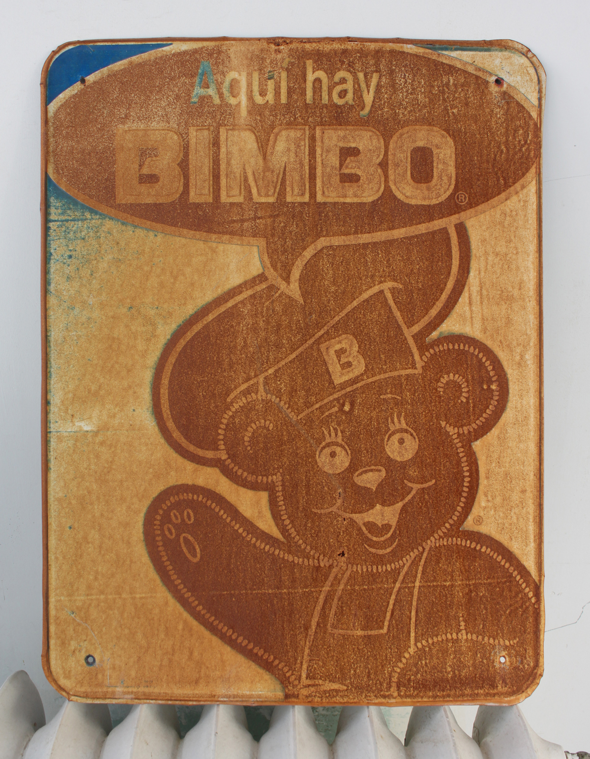 What makes this sign in my collection so fun is the talk bubble with the word BIMBO which is actually the name of a Mexican loaf of bread but we all know what it means in English. Translated it says “Get your Bimbo here.” I also like the way that the image has become a negative of itself as the sun burned out the color and the rust took over. The touch of blue, the white space, the line work all makes for a nicely done design. Found it on the side of an old Mexican neighborhood corner store not far from the mountainside near Scenic Drive. I bought it from the store clerk who first asked the BIMBO salespeople if he could get a new sign because the old sign had seen better days. He got his new sign and I got the priceless one.