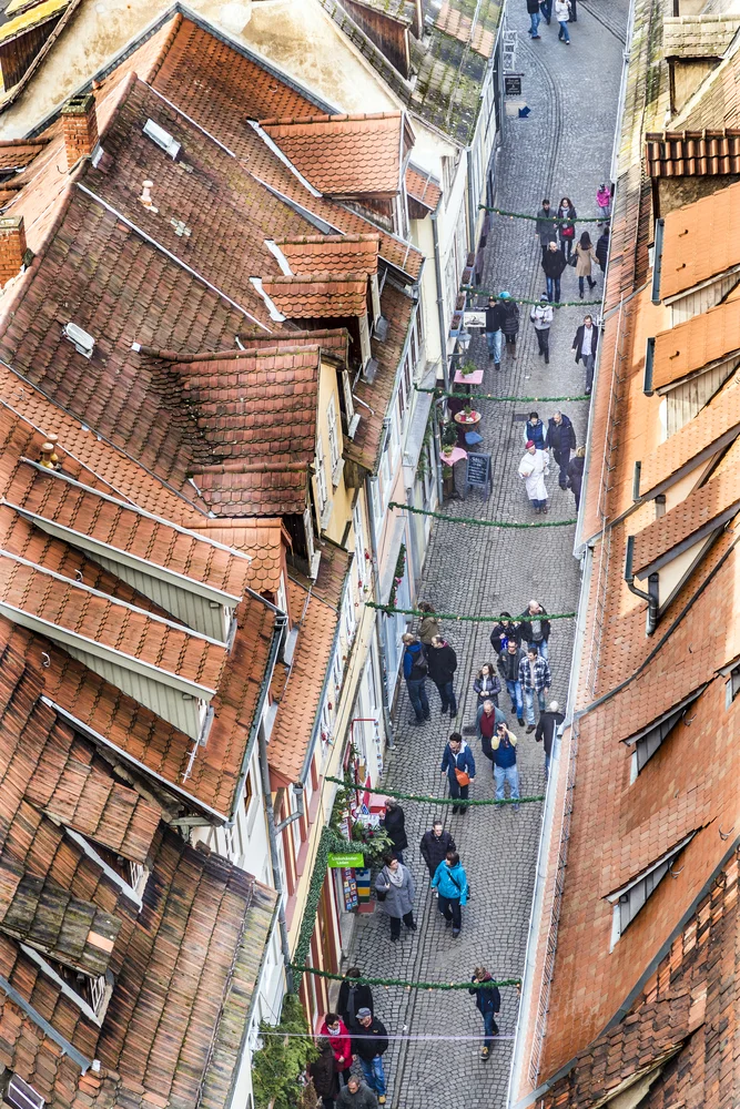 People visit the famous Kramer Bridge lined on each side with timber-framed houses. It has been a merchants place since medieval times.