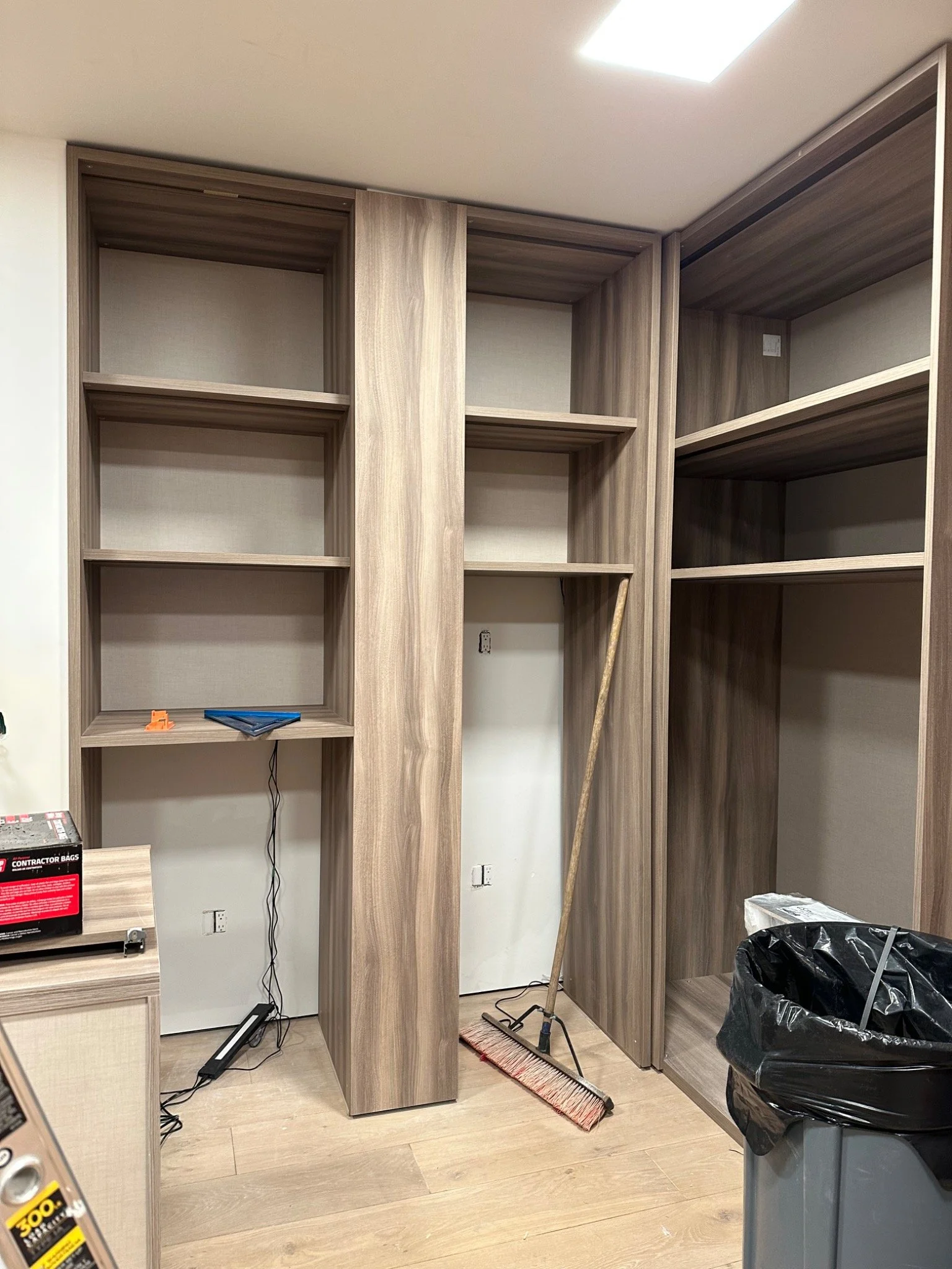In-progress custom closet installation showing shelving layout, field conditions, and storage system coordination by UCON Contemporary Interiors.