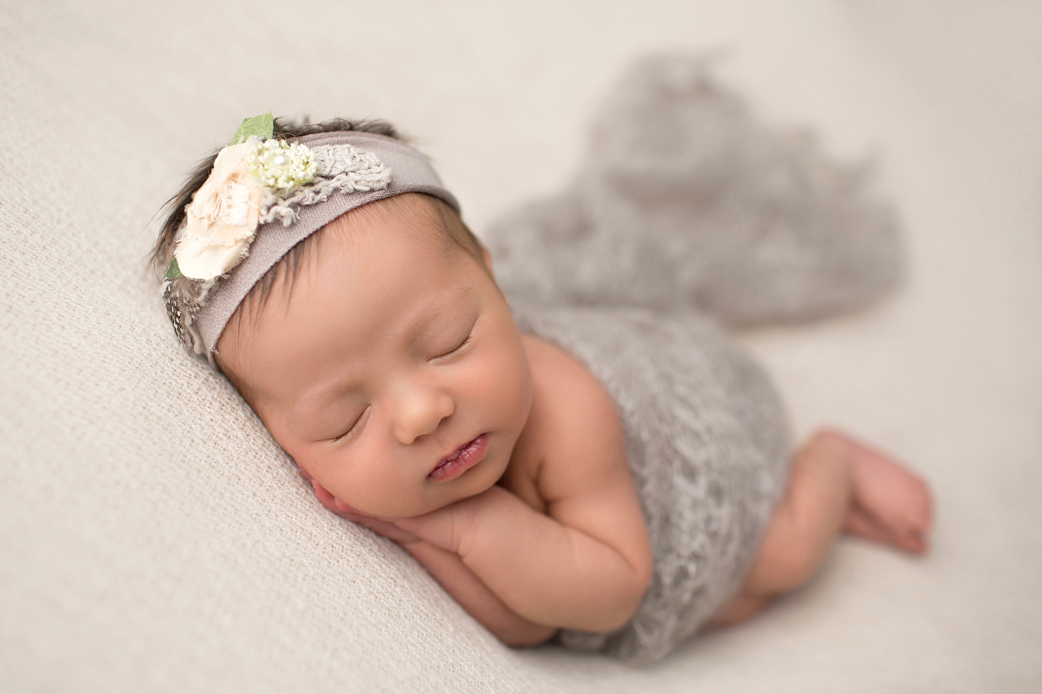 baby with grey flower headband