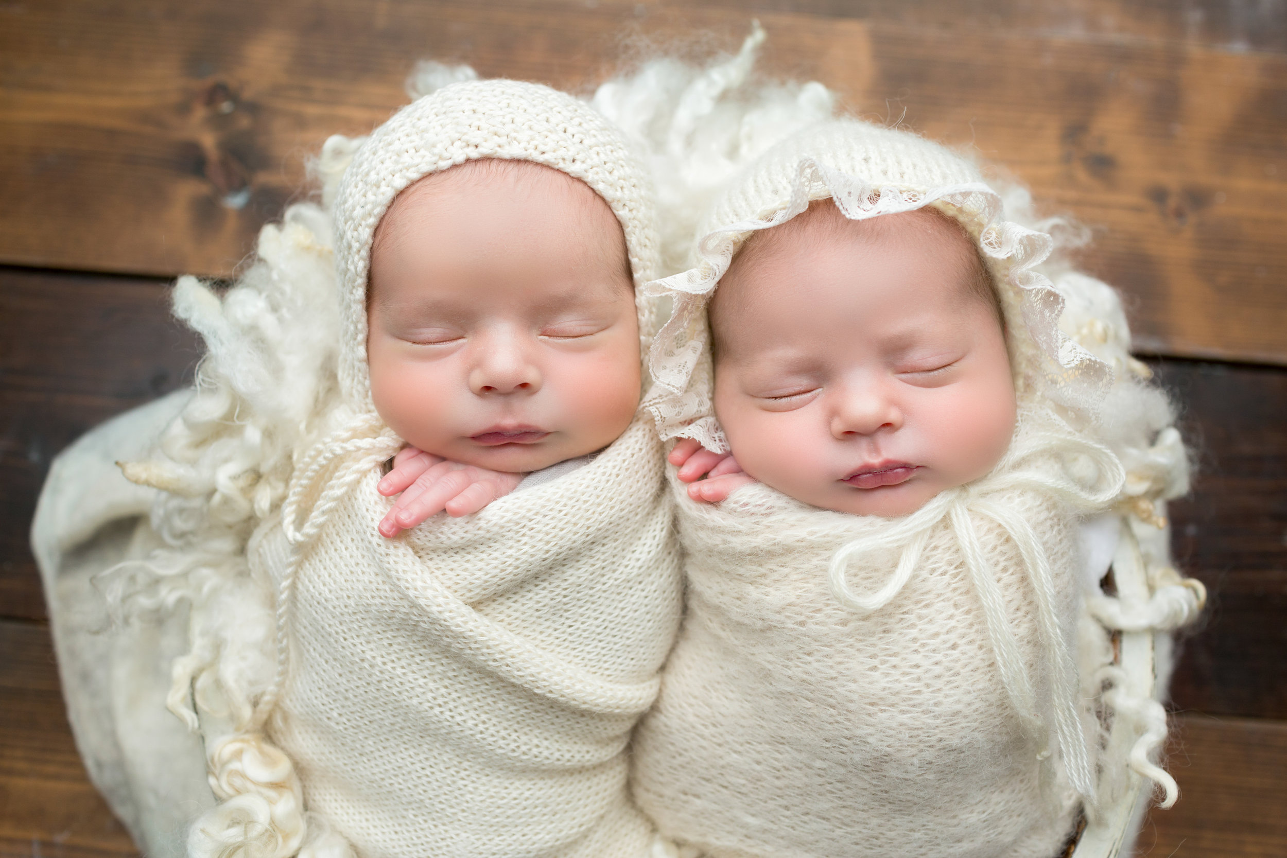 boy/girl twins in cream wraps sleeping peacefully