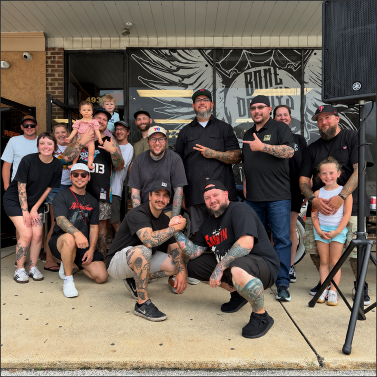 Group photo outside Bonedaddys Tattoo at the annual charity car show