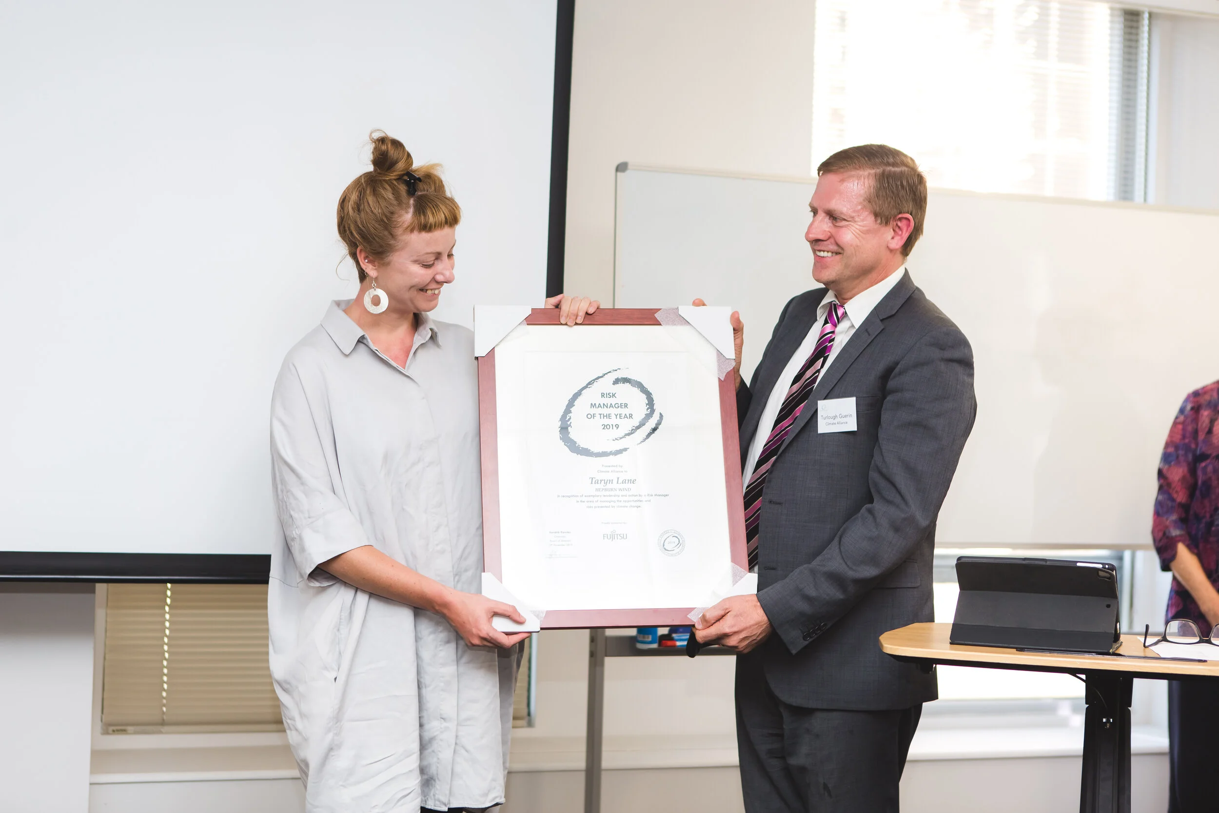  Risk Manager of the Year Award winner Taryn Lane from Hepburn Wind, with Turlough Guerin, Chairman Climate Alliance Board of advisors. The award was sponsored by Fujitsu. 