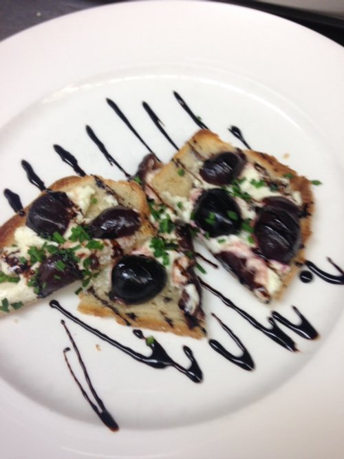 River Bend Bistro's Toasted Flat Bread with Goat Cheese, Cherries, and Balsamic Glaze