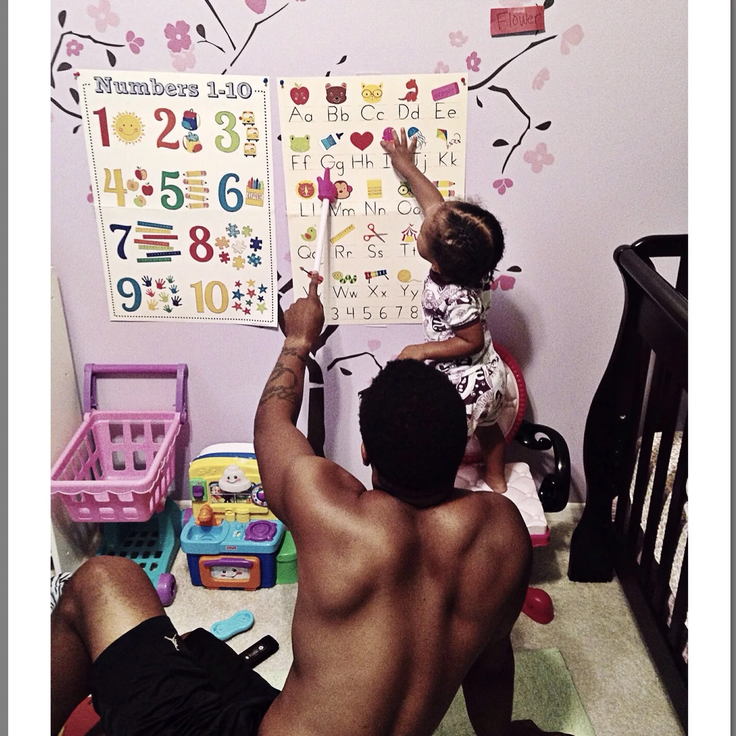 Daddy Wells using a "chart" to go over letters and numbers. Charts work...learn how